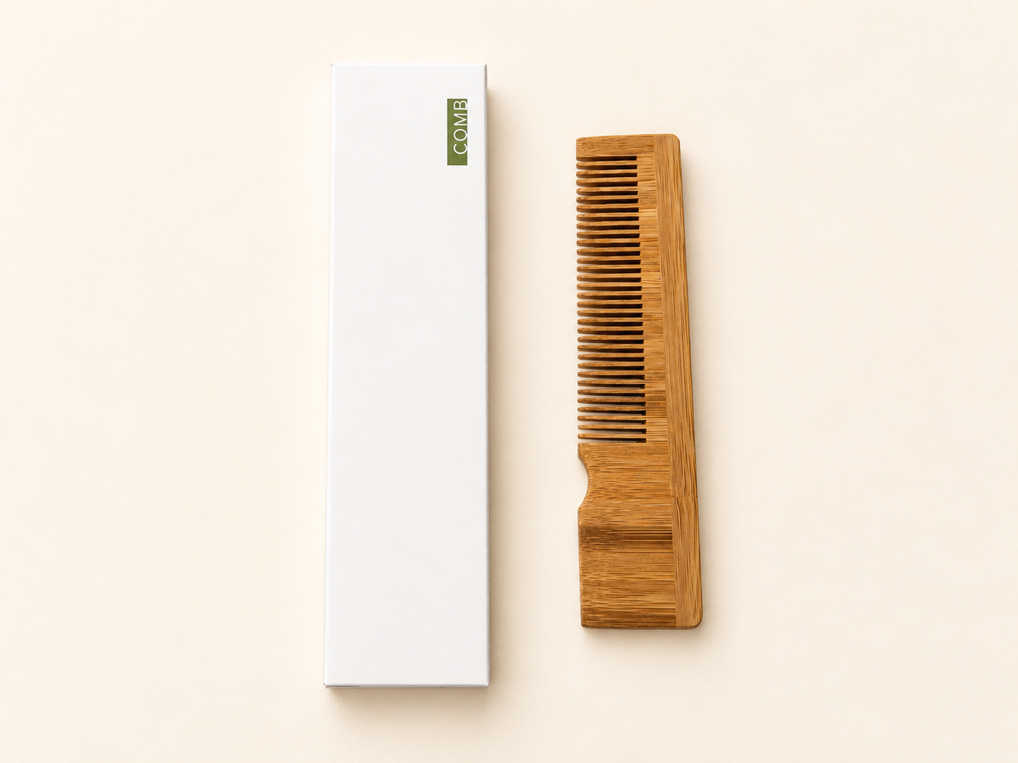 Bamboo hair comb beside a white product box labeled COMB