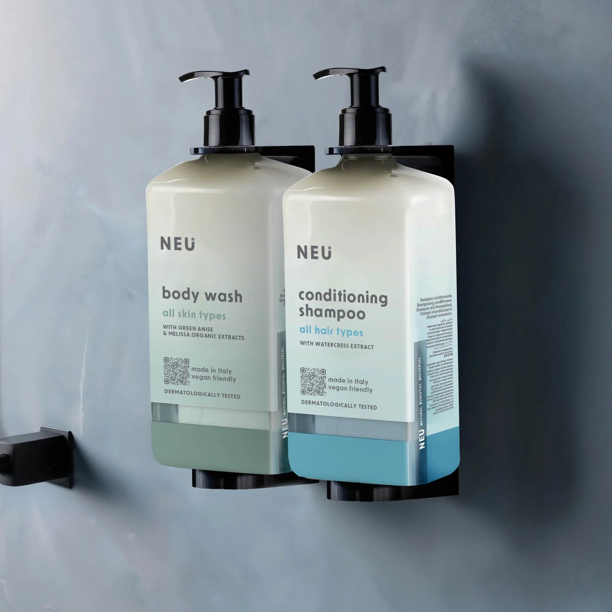 Two wall-mounted NEU dispensers containing body wash and conditioning shampoo
