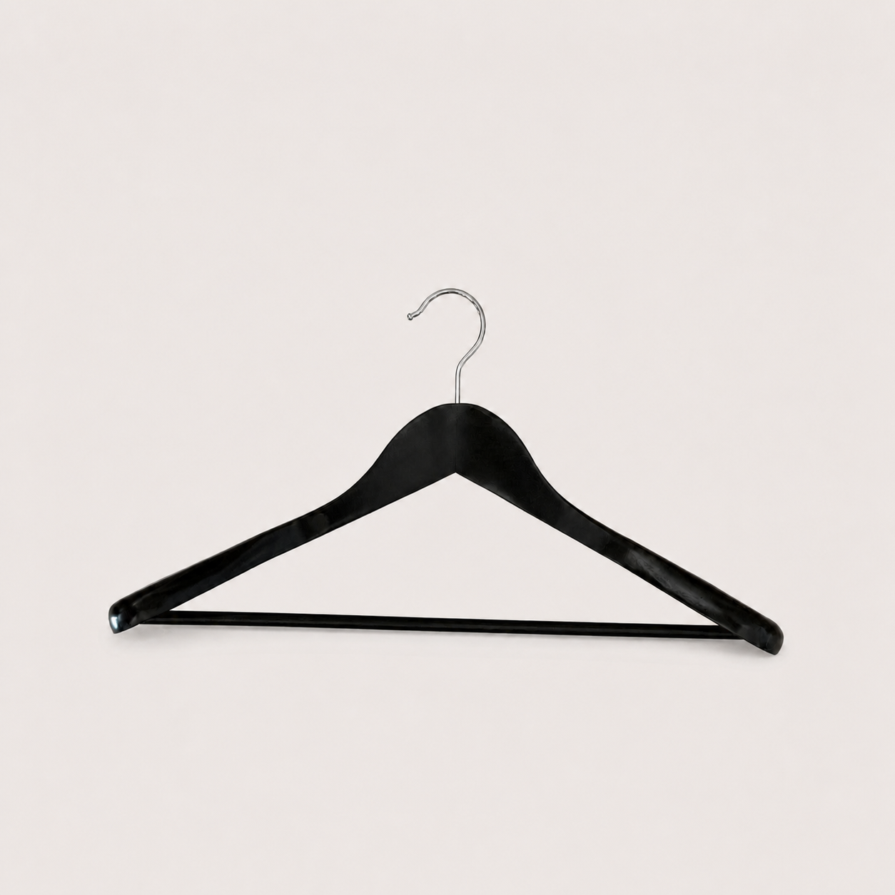 Black clothes hanger with a metal hook on a light background