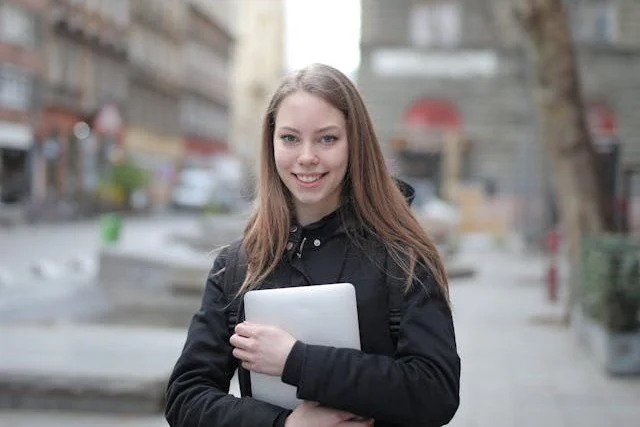 woman-in-black-long-sleeve-shirt-holding-white-tablet-computer