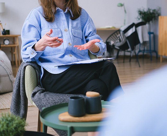 Woman therapist talking with patient