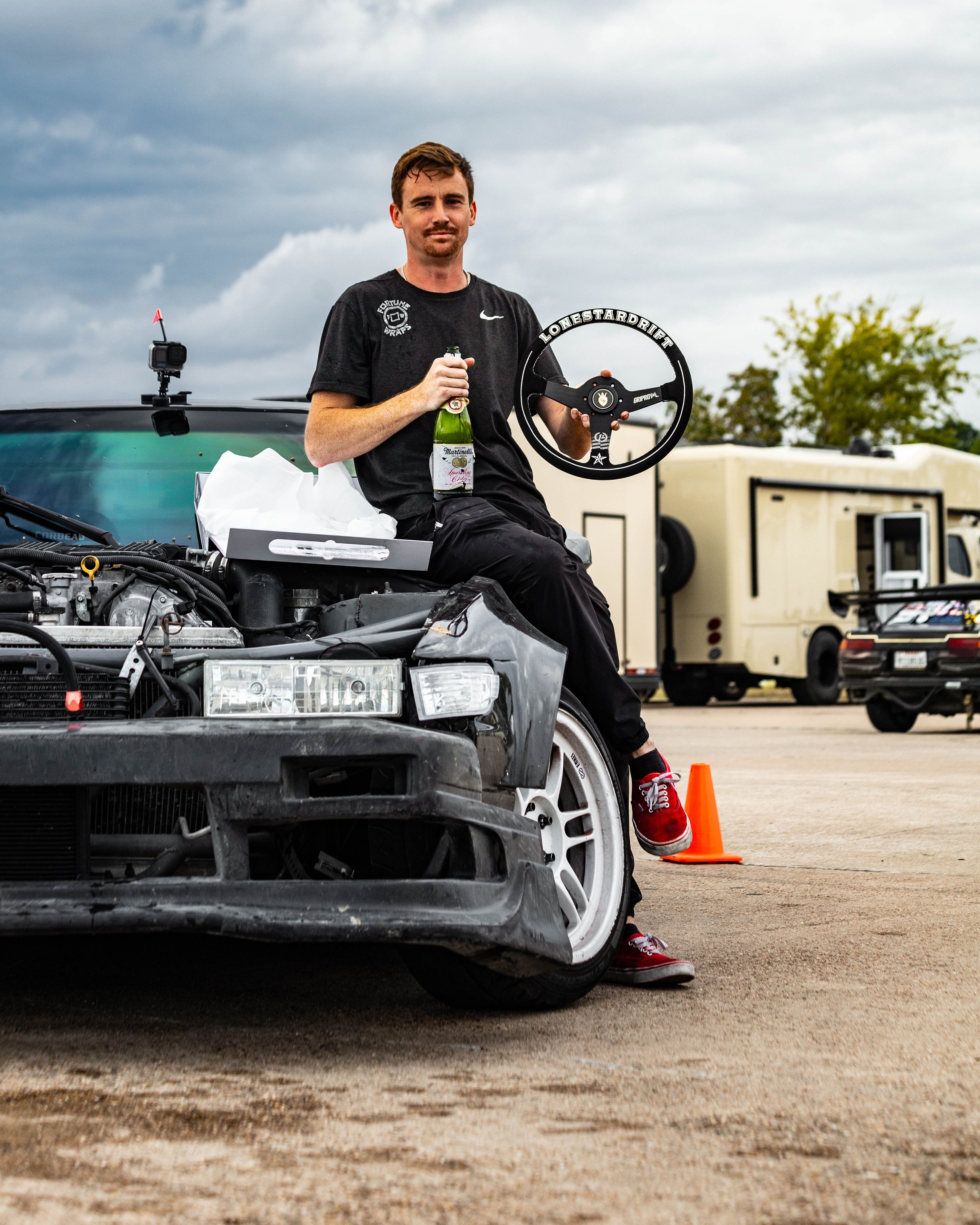Brian, an owner, Posing with his steering wheel trophy after his first Pro am round win in lonestar drift with his 240sx drift build with a 370z engine