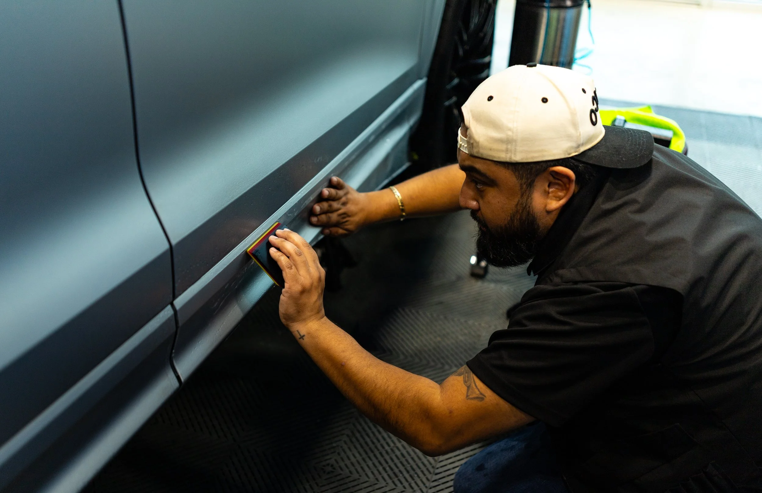 Installing Stealth PPF On a balck Audi SQ8 lining up the edges to make sure we have a seamless finish on each panel covering all of the gloss