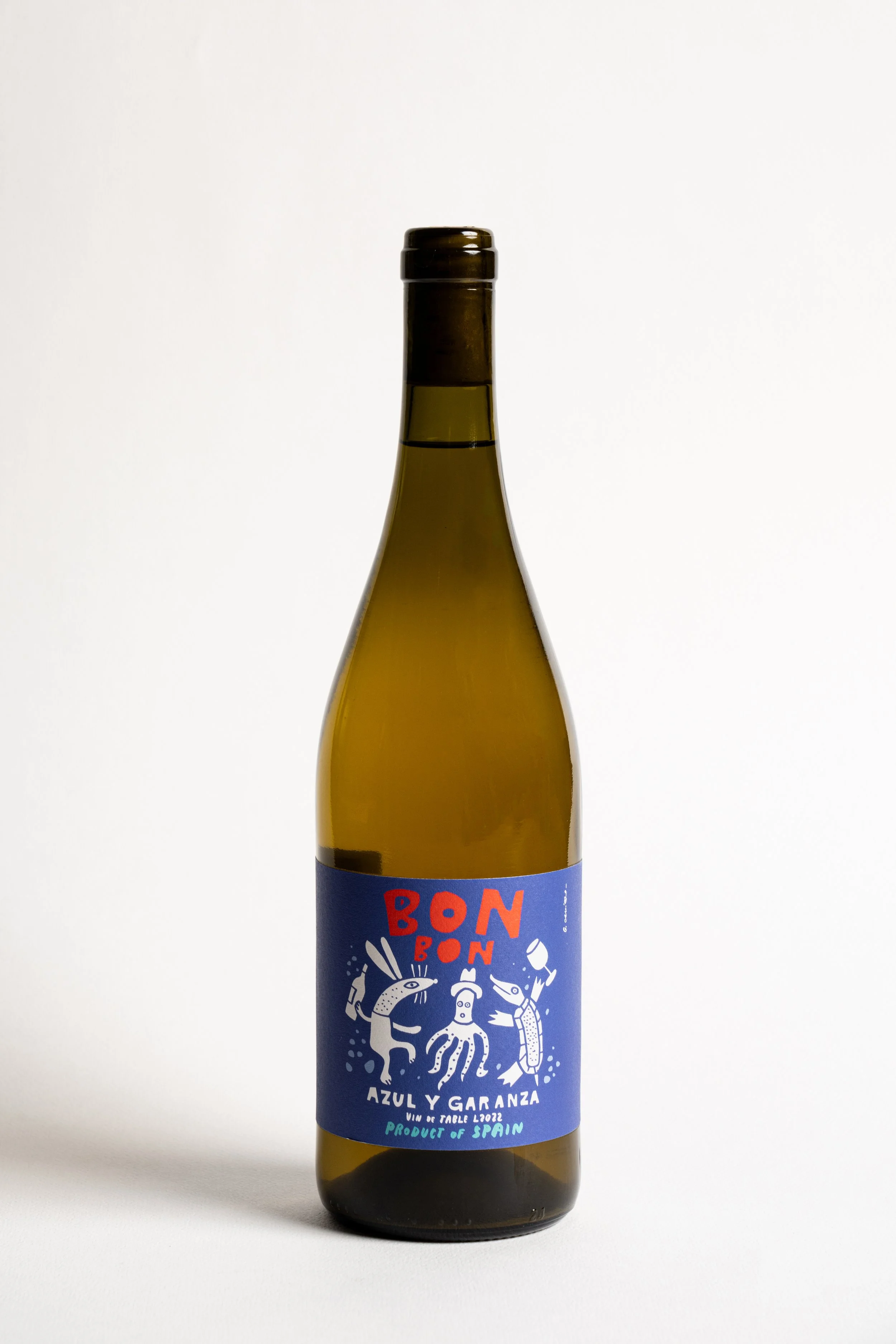A bottle of wine with a blue label featuring white illustration of sea creatures and red text reading "BON BON".