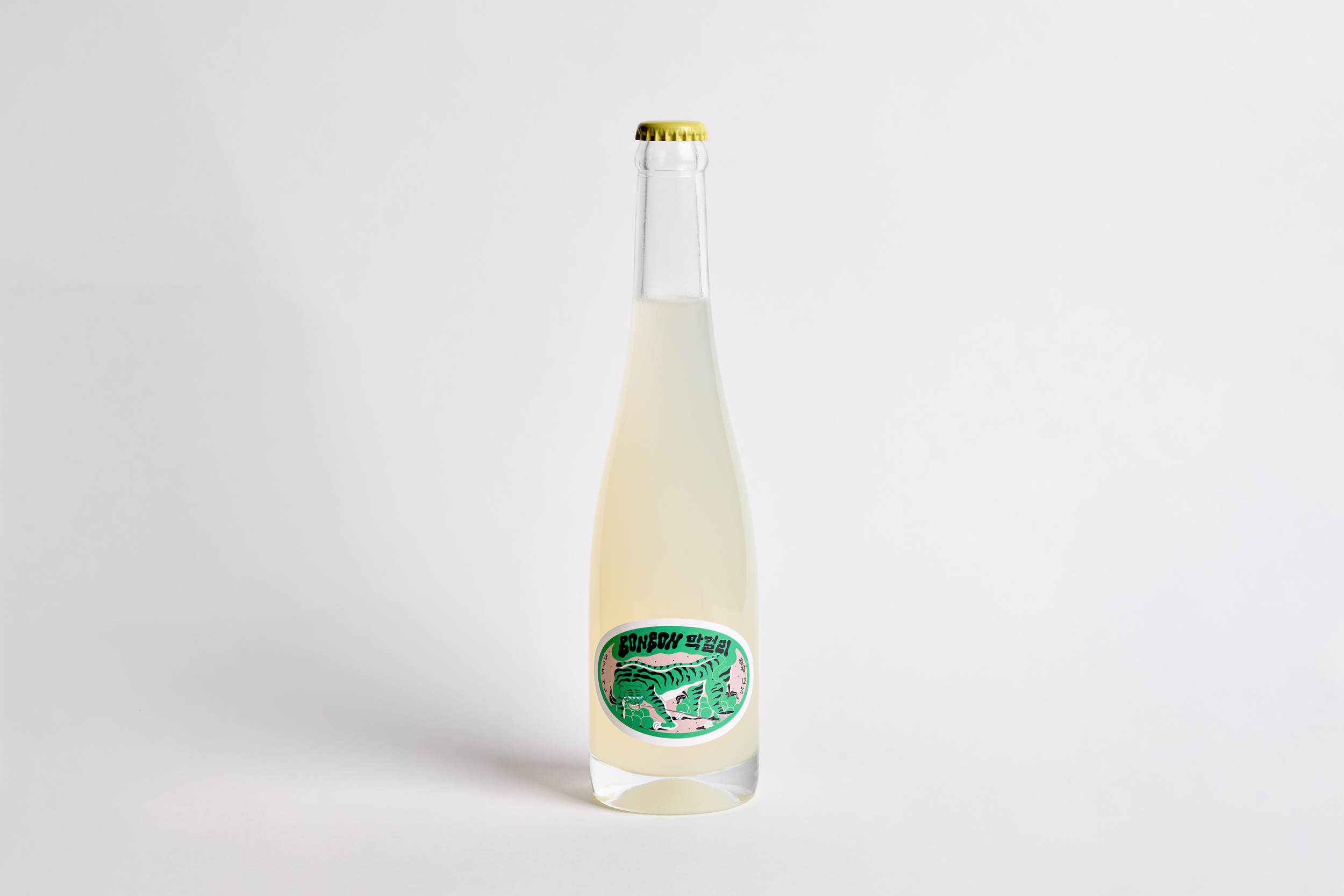 A bottle of wine with a blue label featuring white illustration of sea creatures and red text reading "BON BON".