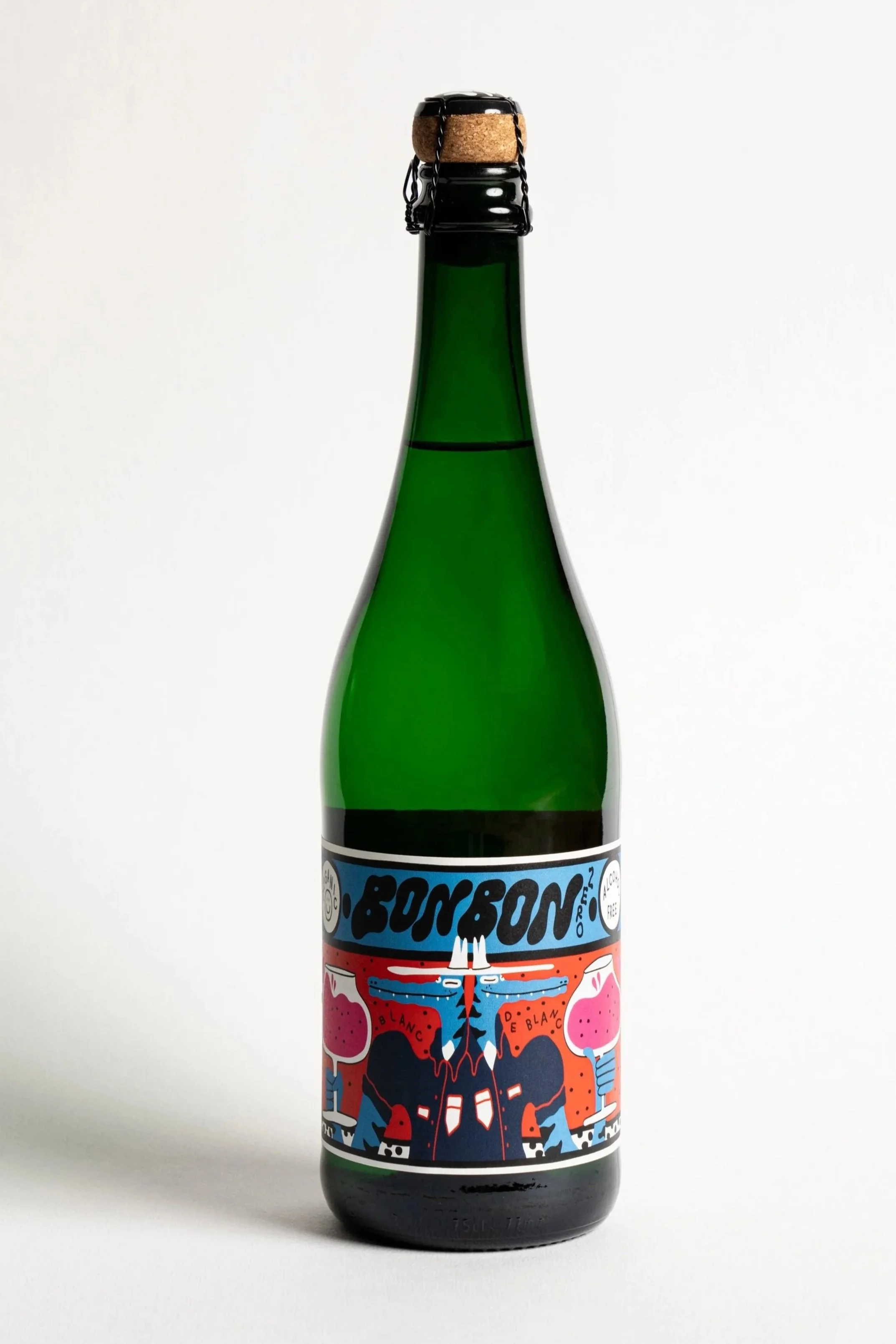 A green glass bottle of Bonne Bonne cider with a black screw cap and a colorful illustrated label featuring abstract shapes, a cow, and a cityscape.
