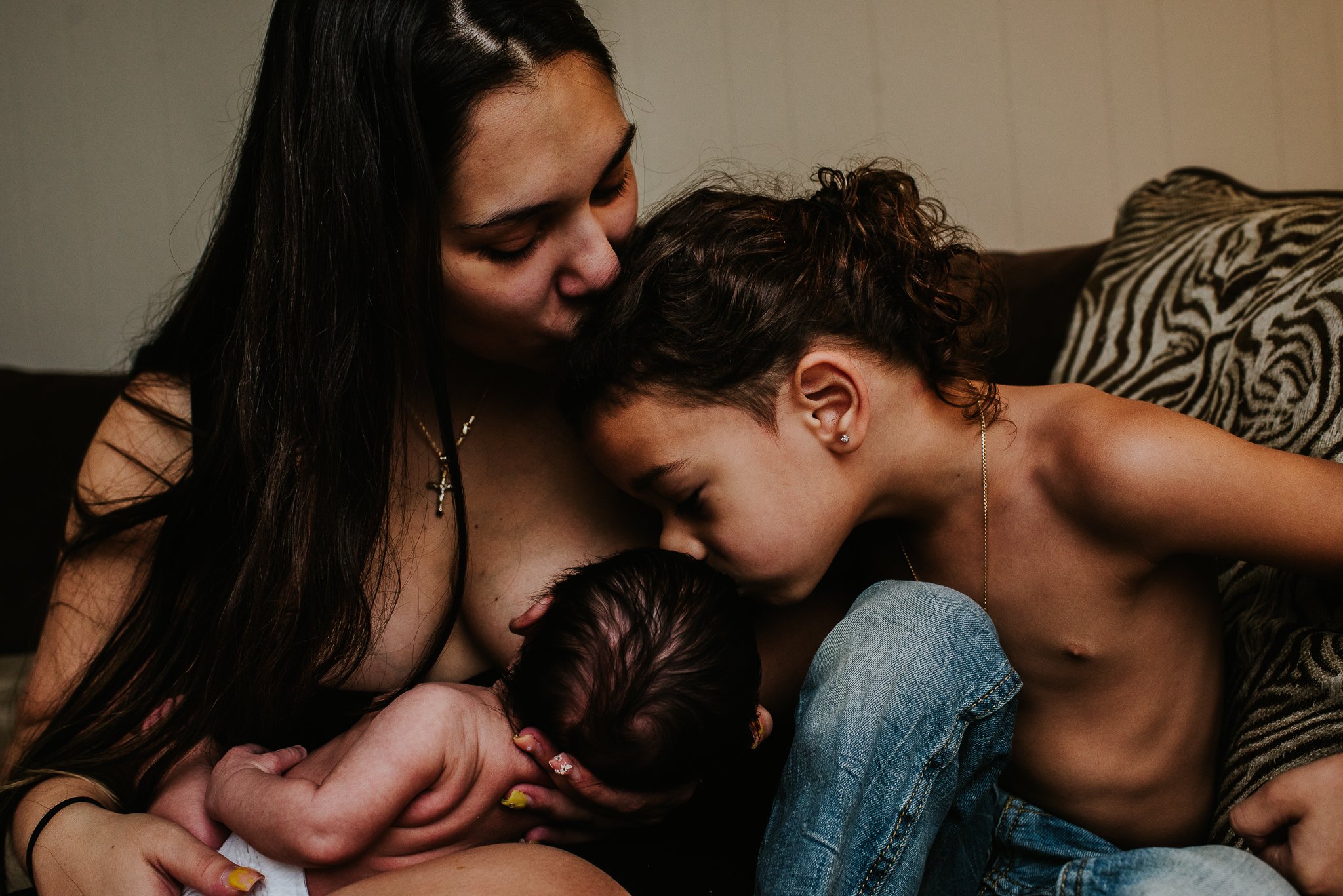 Oxytocin-surge-newly-postpartum-mother-kisses-son-who-kisses-newborn-while-nursing