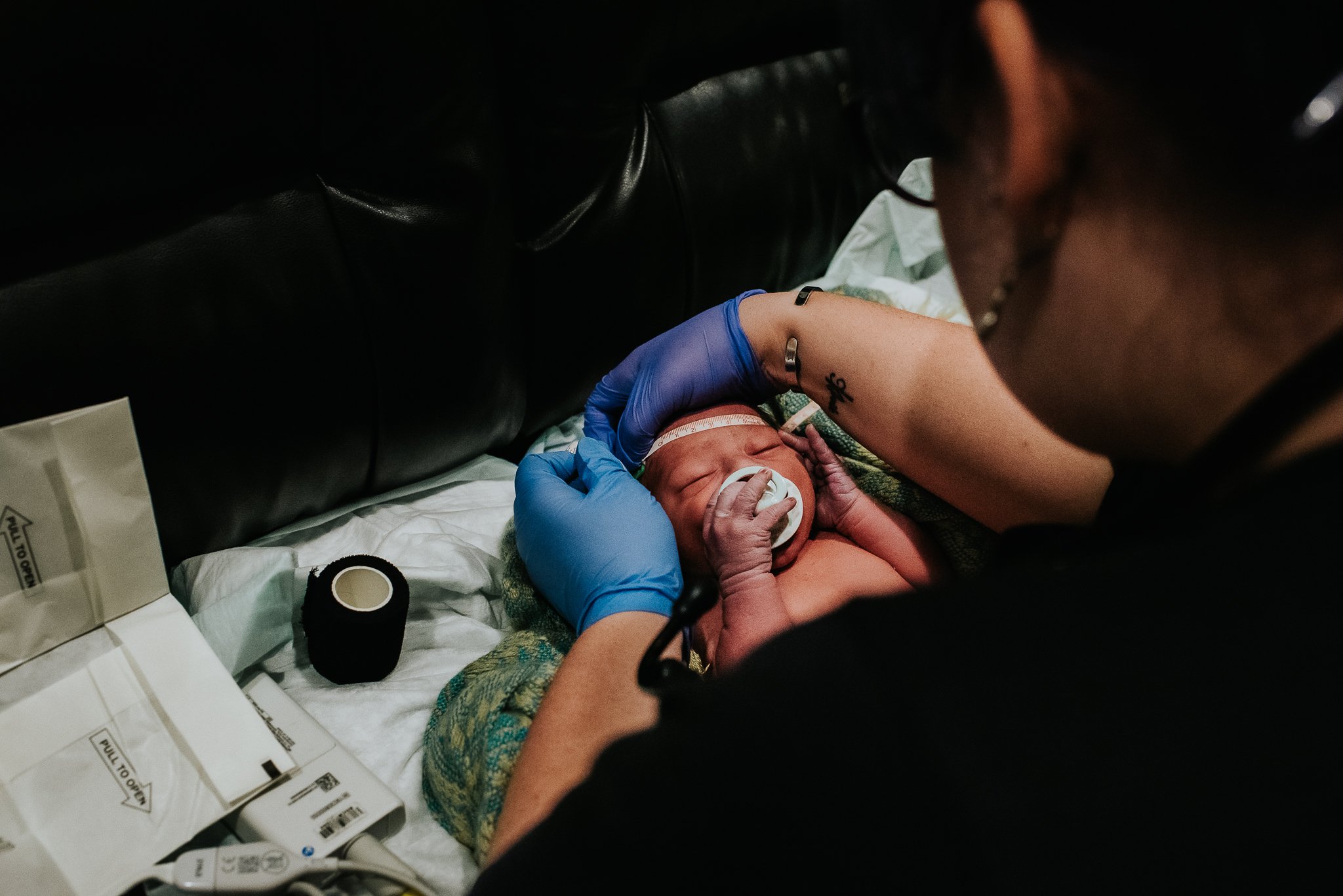 Badger-and-Quill-Photography-documents-midwife-doing-newborn-exam