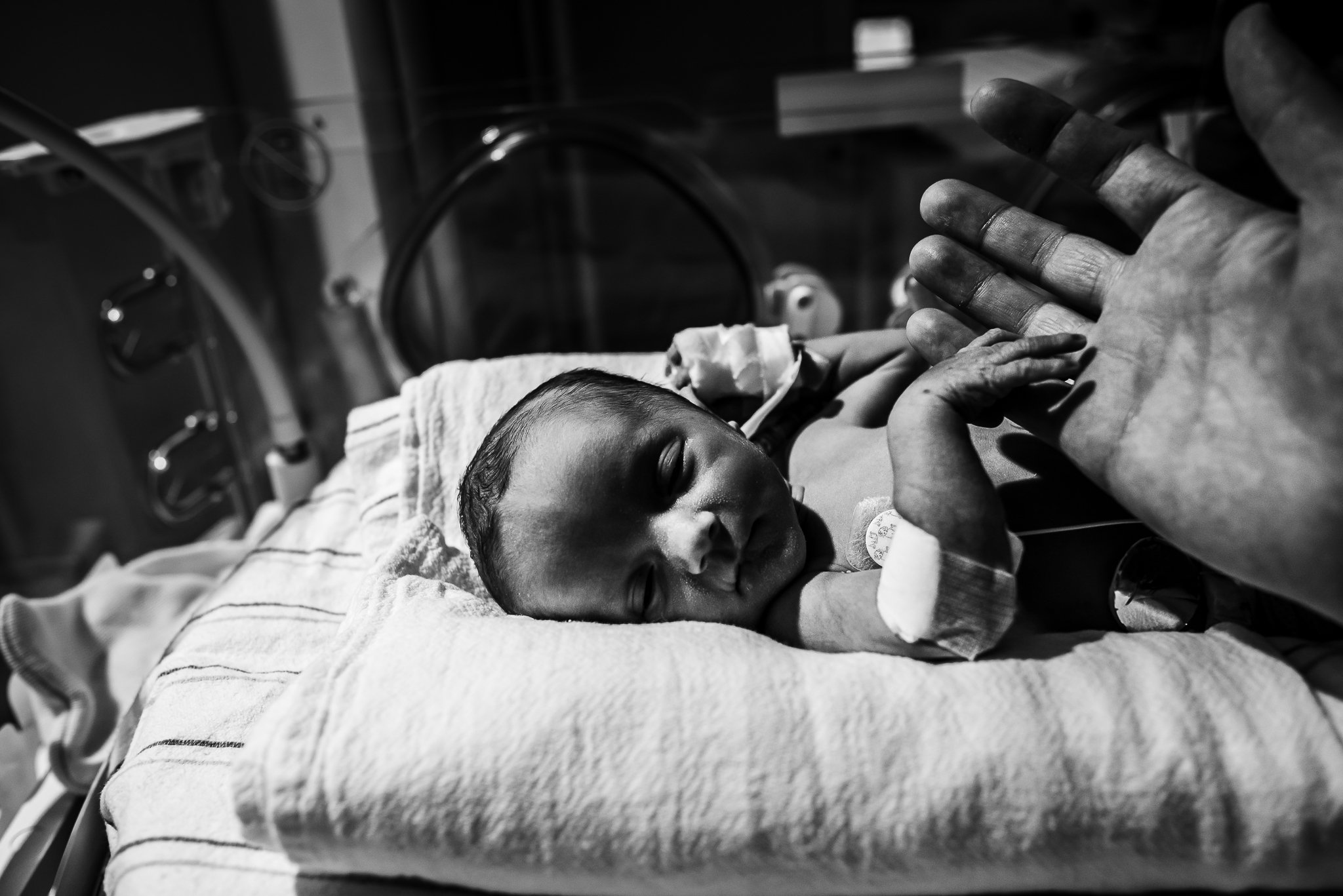 NICU-baby-holds-dads-hand-in-warmer-Geisinger-Danville-PA