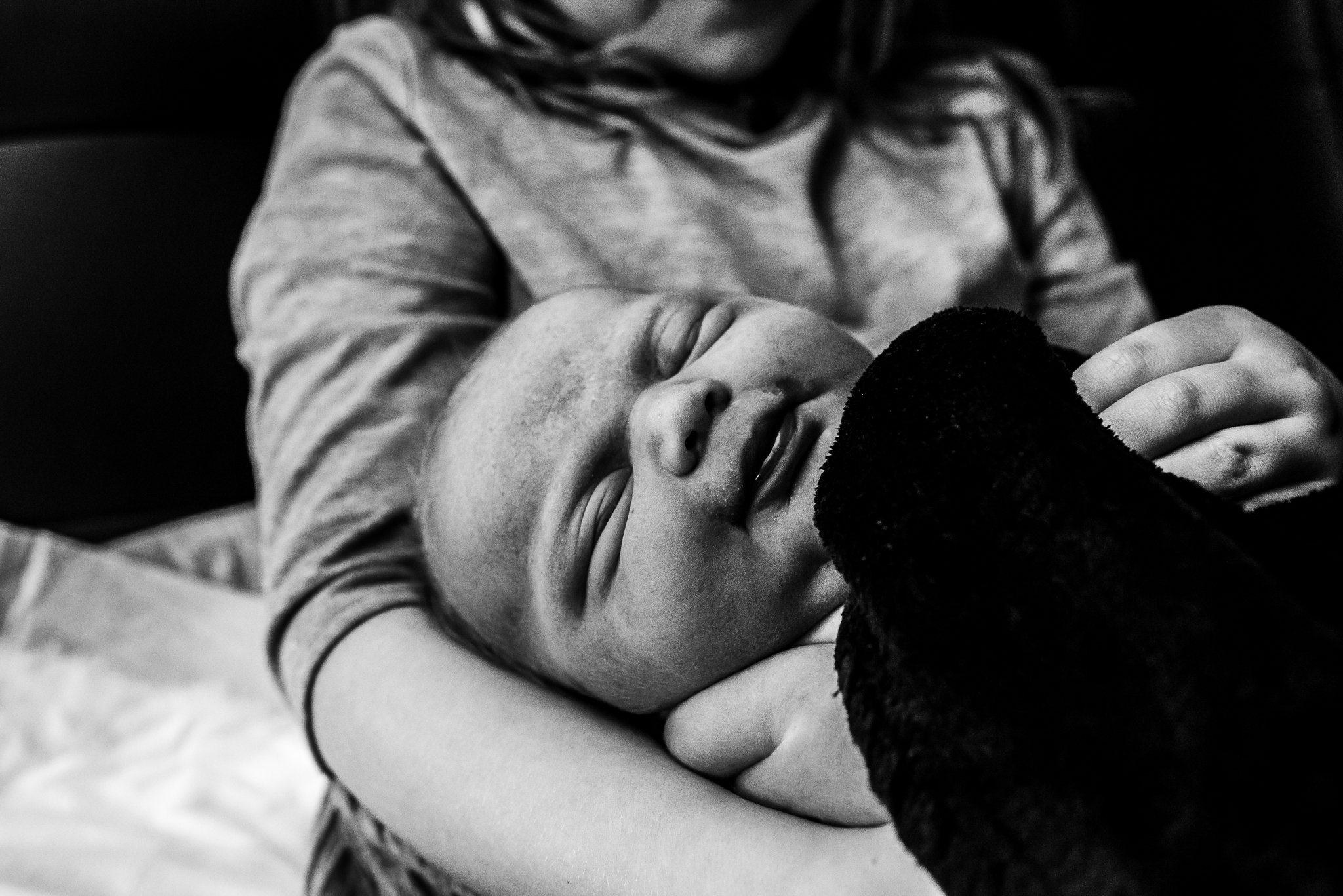 Newborn-held-by-older-sibling-postpartum-central-pa-premier-birth-photography