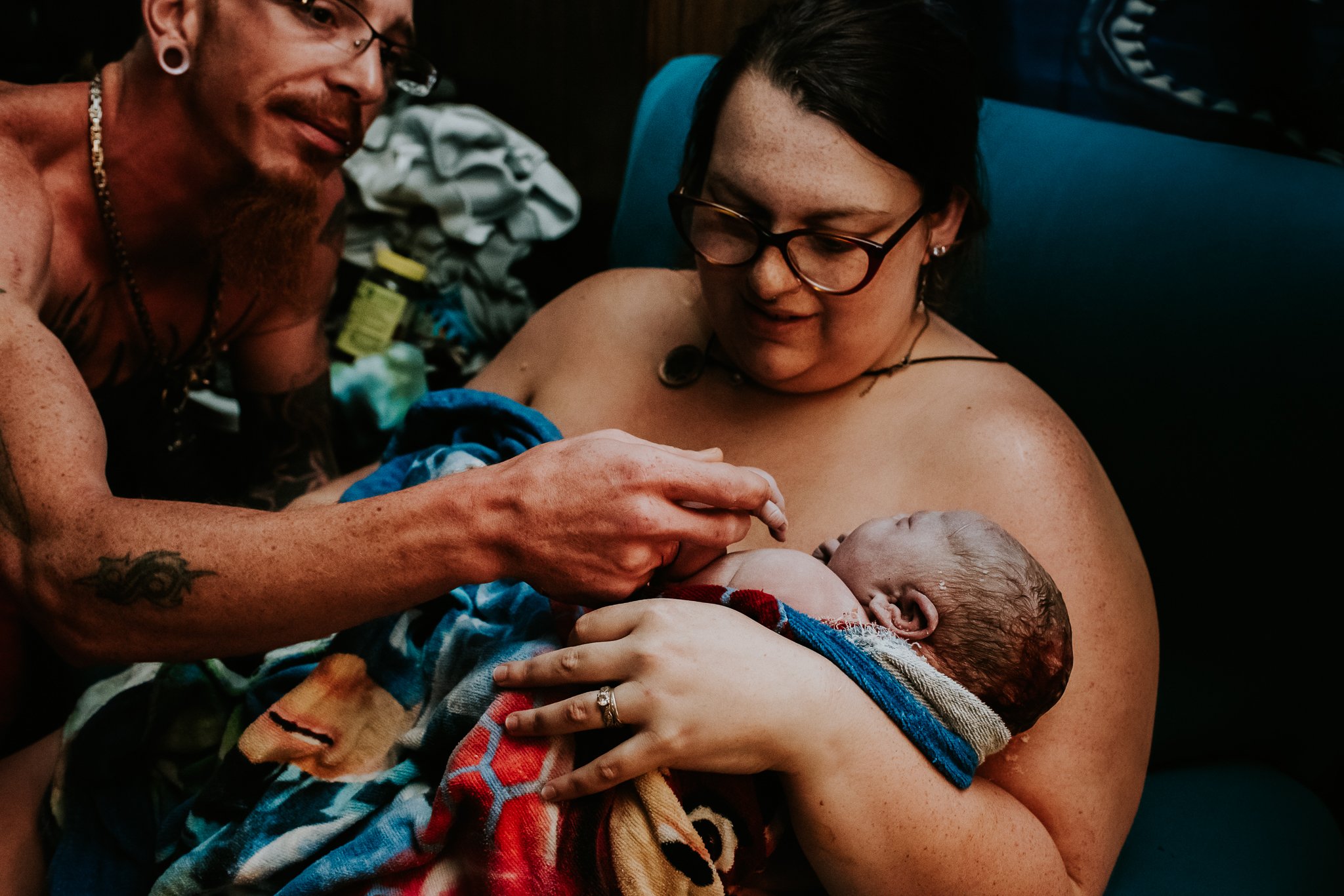 Partner-examines-newborn-while-mother-holds-postpartum-central-PA