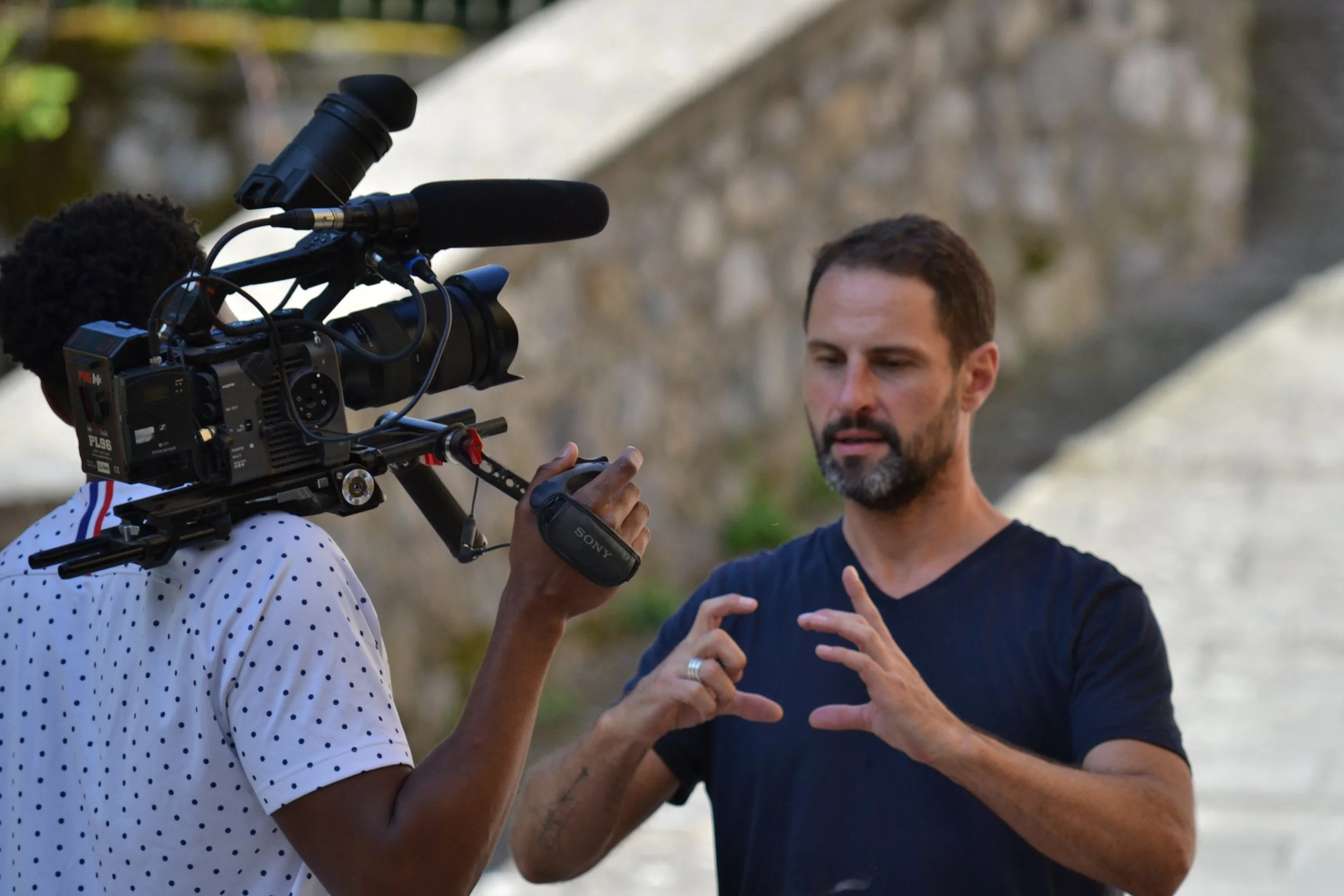 Scott Thompson speaking to a television camera during an outdoor interview