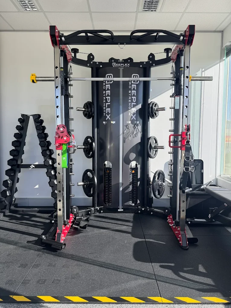 Workout machine with weights and resistance bands in a gym.