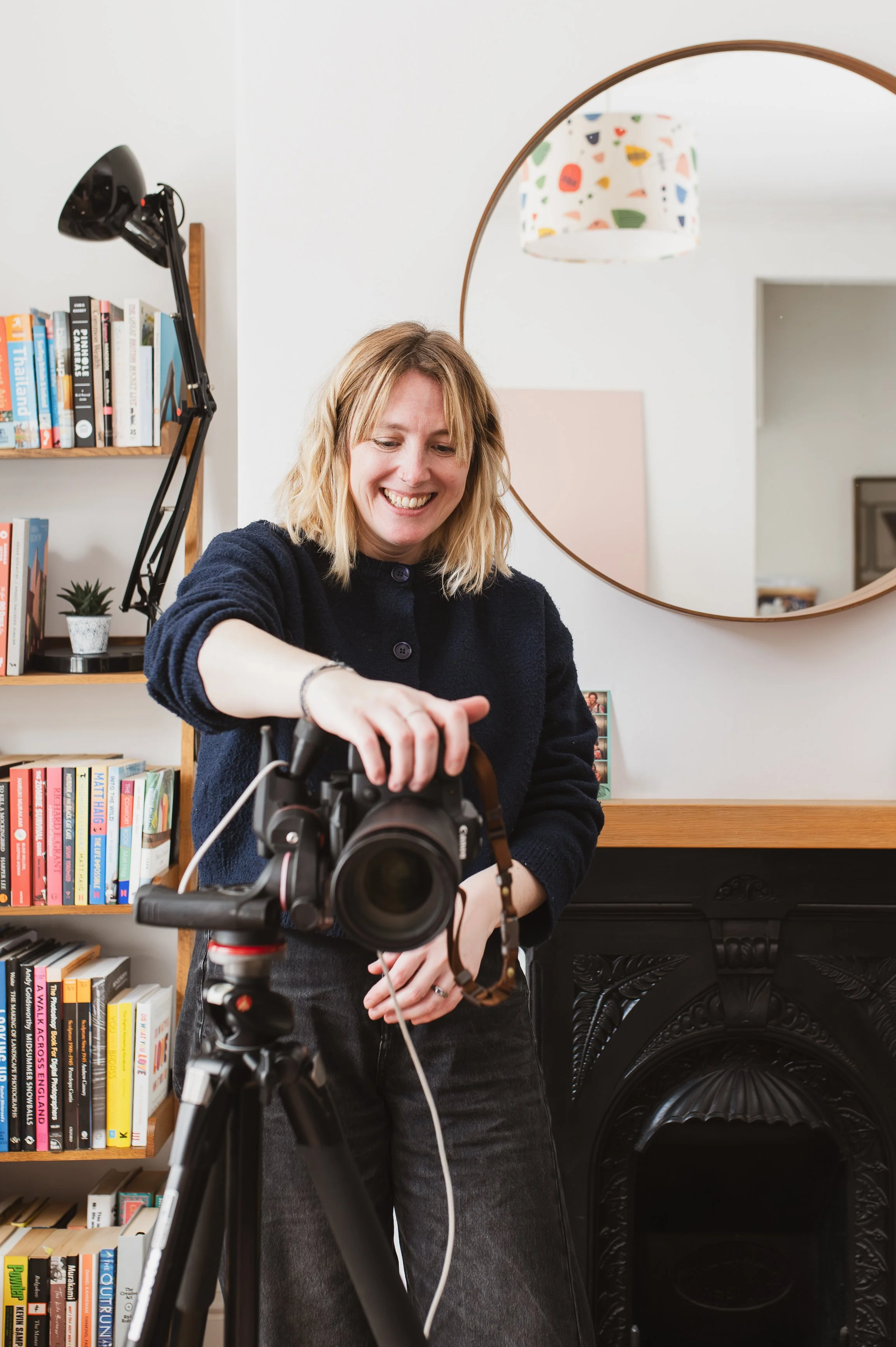  Faye Hedges standing behind a camera. 