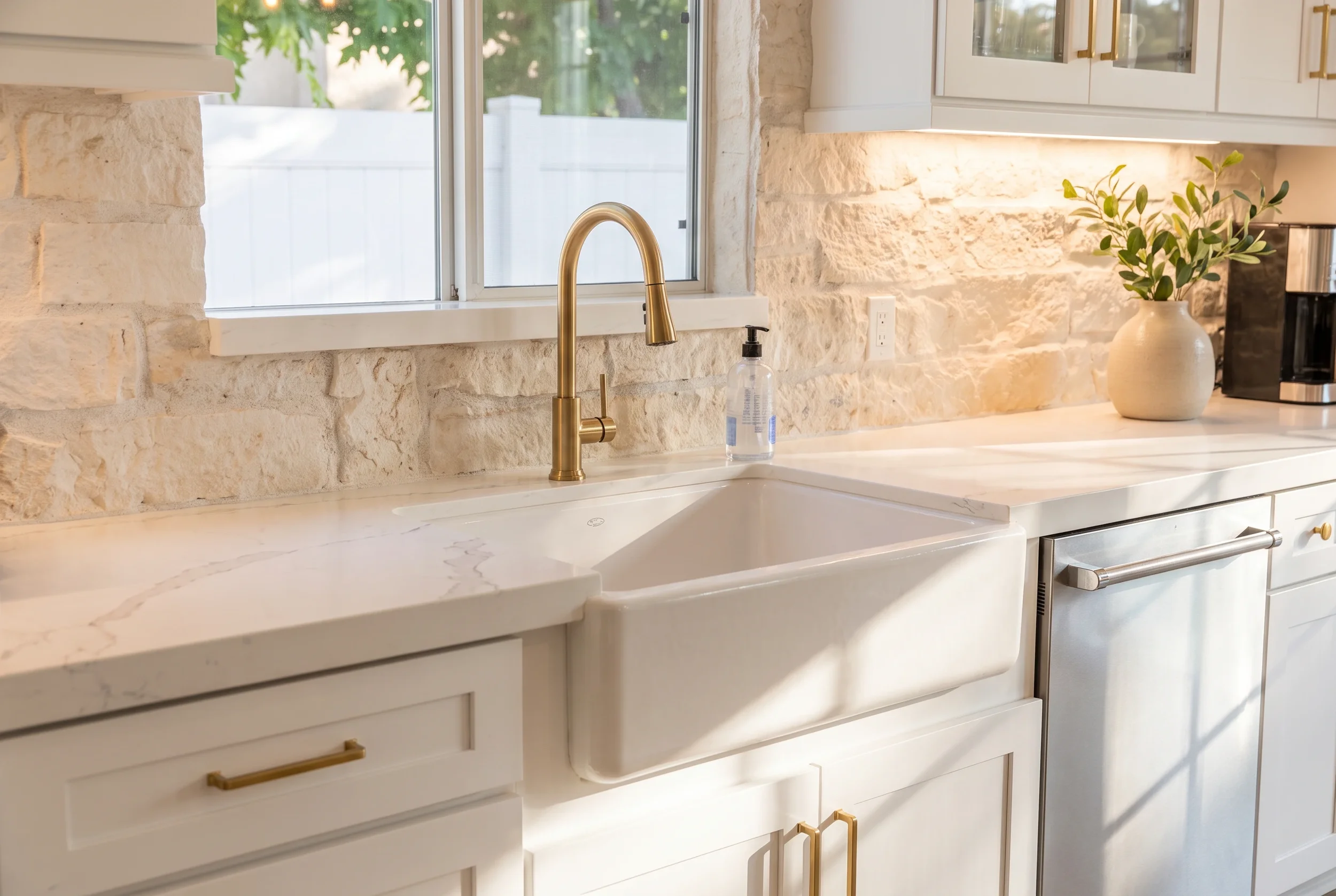 A wide-angle portfolio view of a luxury kitchen remodel by JC Custom Cabinets, showcasing a custom barley oak wood island with minimalist eat-in counter stools, white Shaker cabinetry, and matching glass cloche pendant lighting.