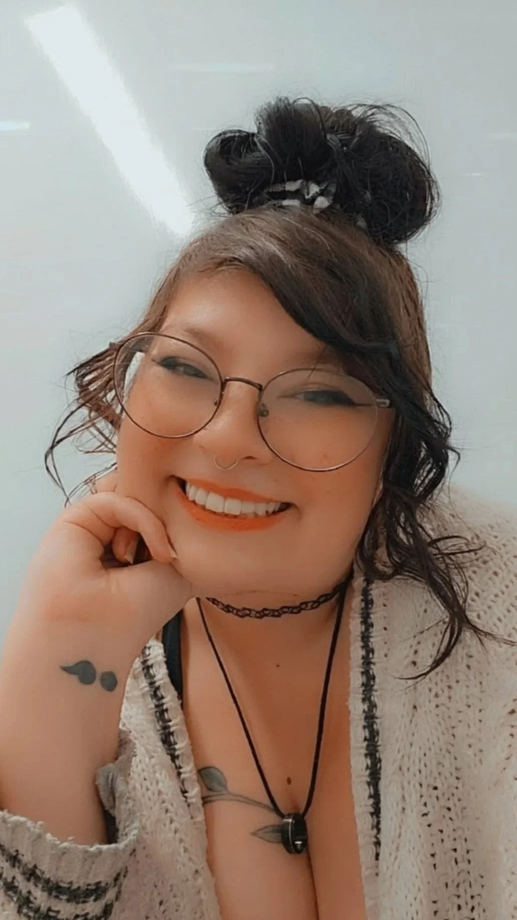 A picture of me, Sam. I have black hair, a nose ring, some ear piercings, glasses, and a few tattoos, 2 of which are visible in this photo. Memorial Vine on my chest and a Semicolon on my wrist. (3 of 4 tattoos can be completely hidden)