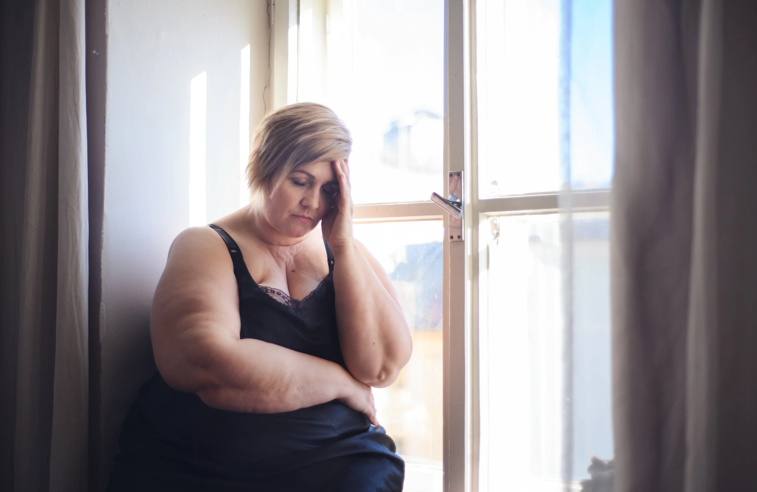 Depressed Caucasian woman from Naperville, IL, dealing with the challenges of weight gain.