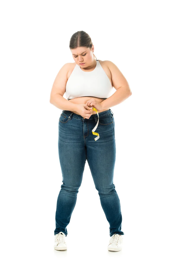 Woman measuring her waist after regaining weight following a gastric sleeve