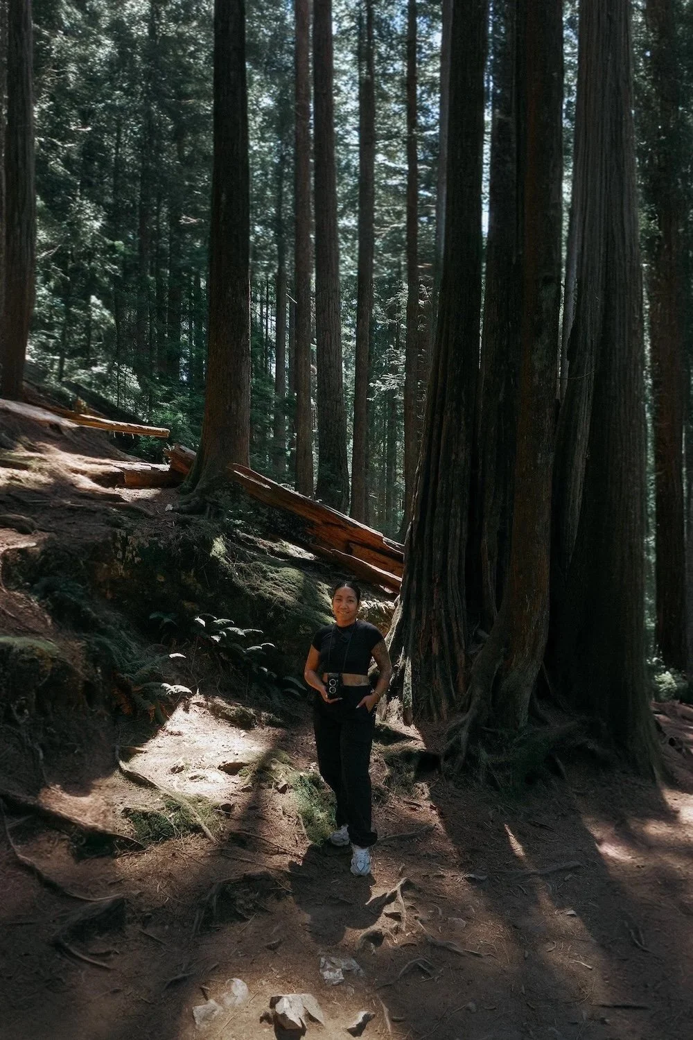 Midnight Creative Agency founder Ariana Genilla holding her camera in the mountains, representing Las Vegas social media agency leadership and hospitality marketing expertise.