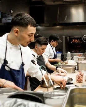 A dynamic shot of a busy kitchen staff serving hospitality clients, captured by Midnight Creative Agency, a leading Las Vegas marketing agency.