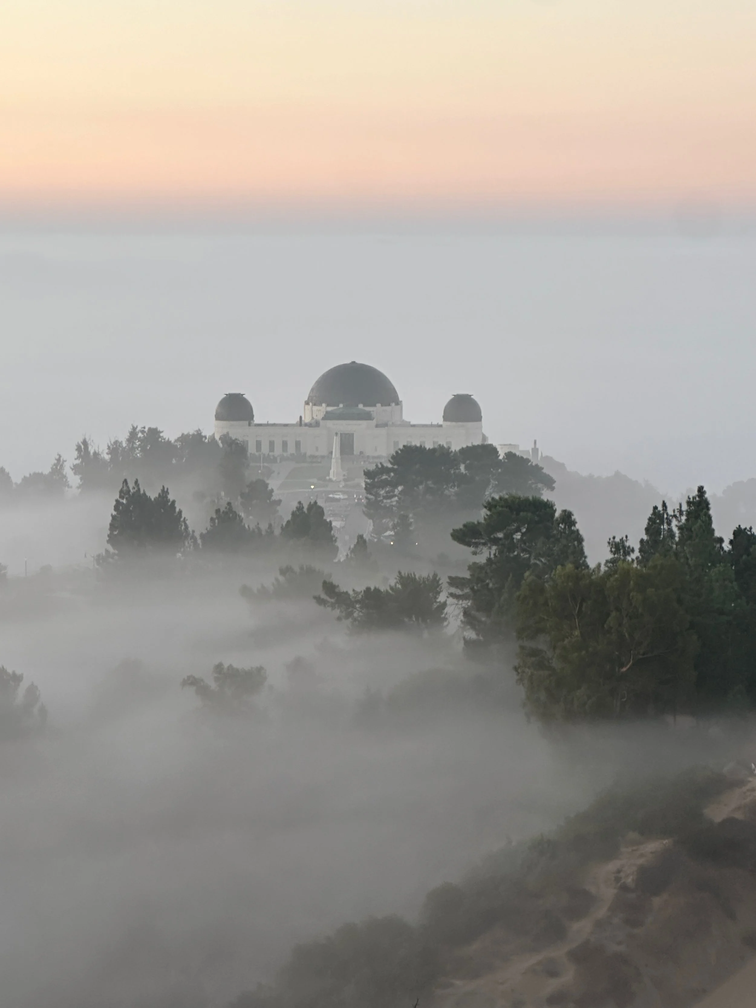 Sunrise over Griffith Observatory viewed from a hidden Griffith Park ridgeline during an E Bike Tours Los Angeles guided tour