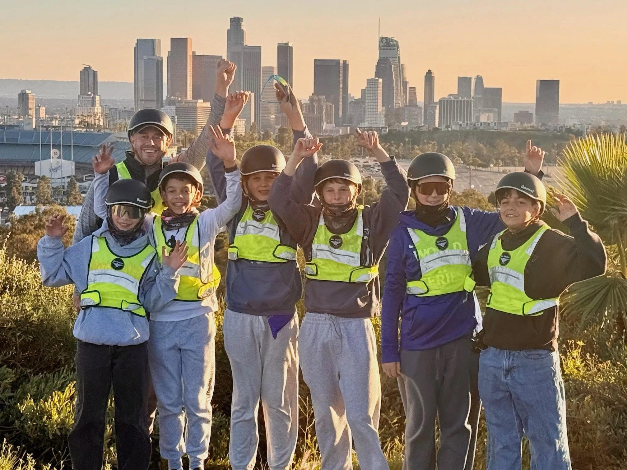 Group of teenagers riding ebiketours with dodger stadium in background