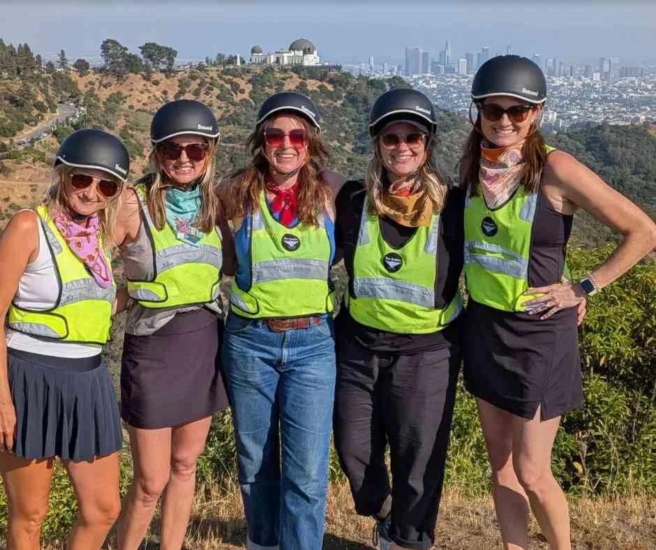 Group of friends enjoying a Griffith Park e-bike adventure with Hollywood Sign views