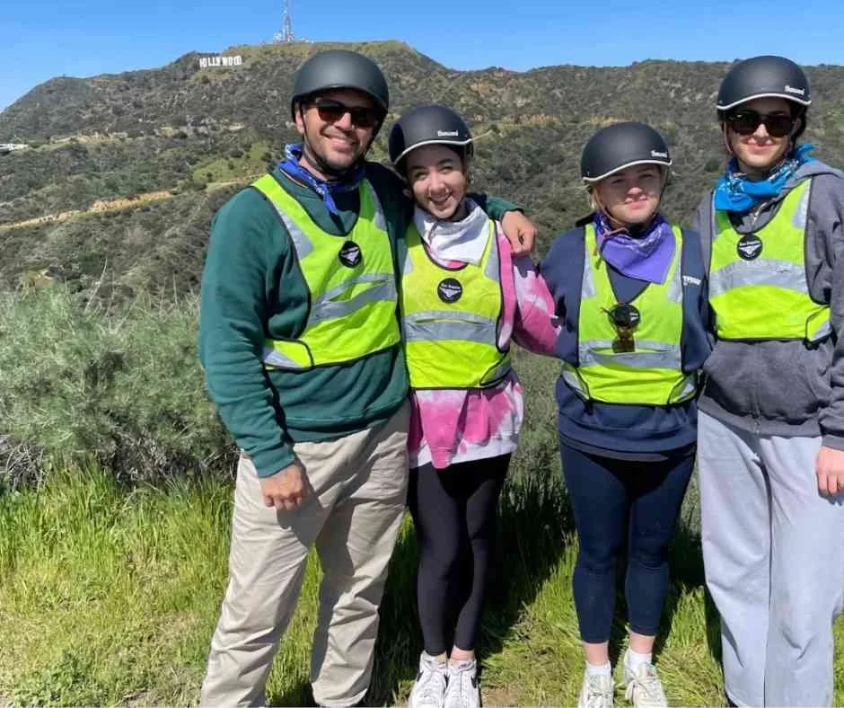 Father and daughter and her friends enjoying a private Griffith Park e-bike tour with Hollywood Sign views