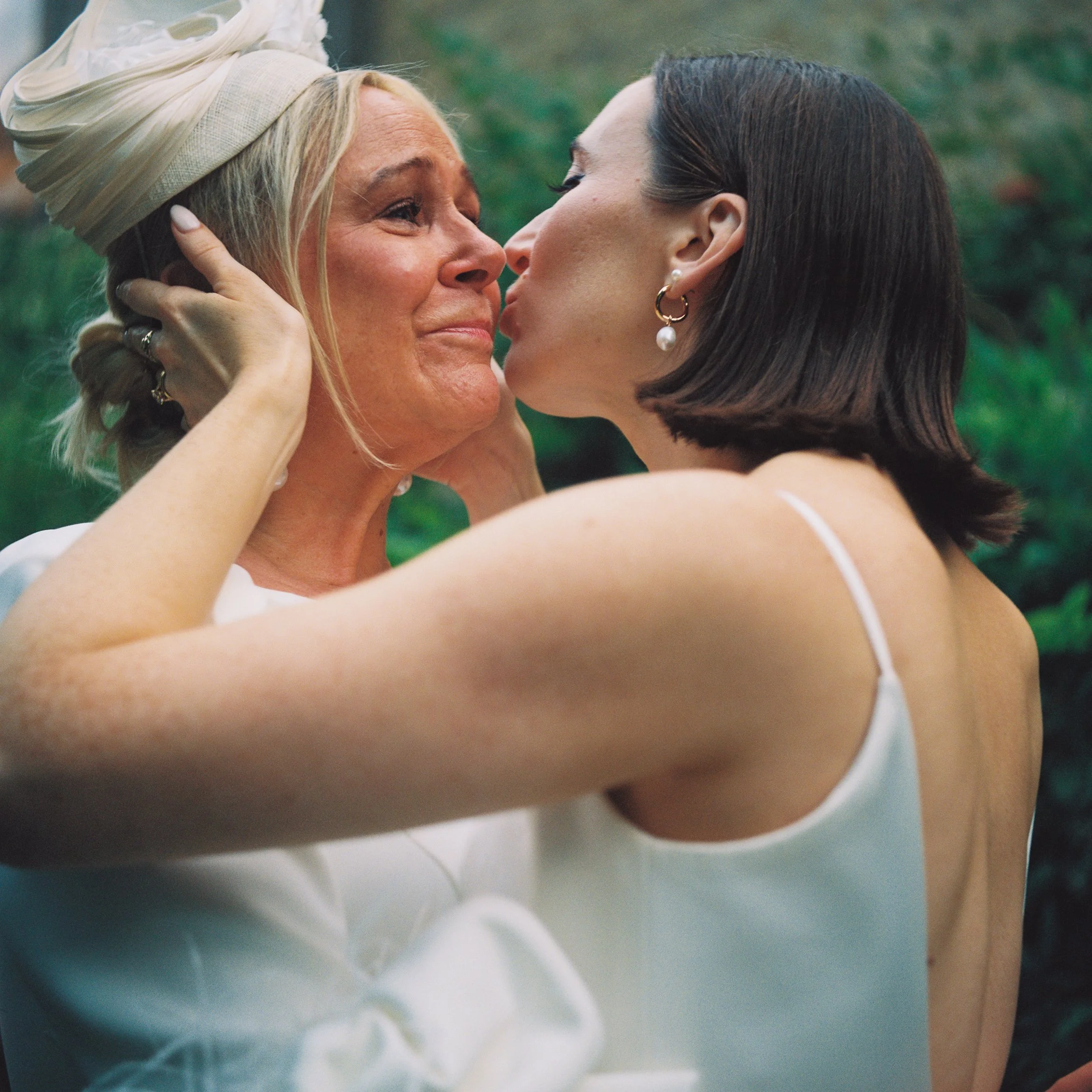 Film image of a bride and mother embracing, shot on a Yashica 635 medium format camera