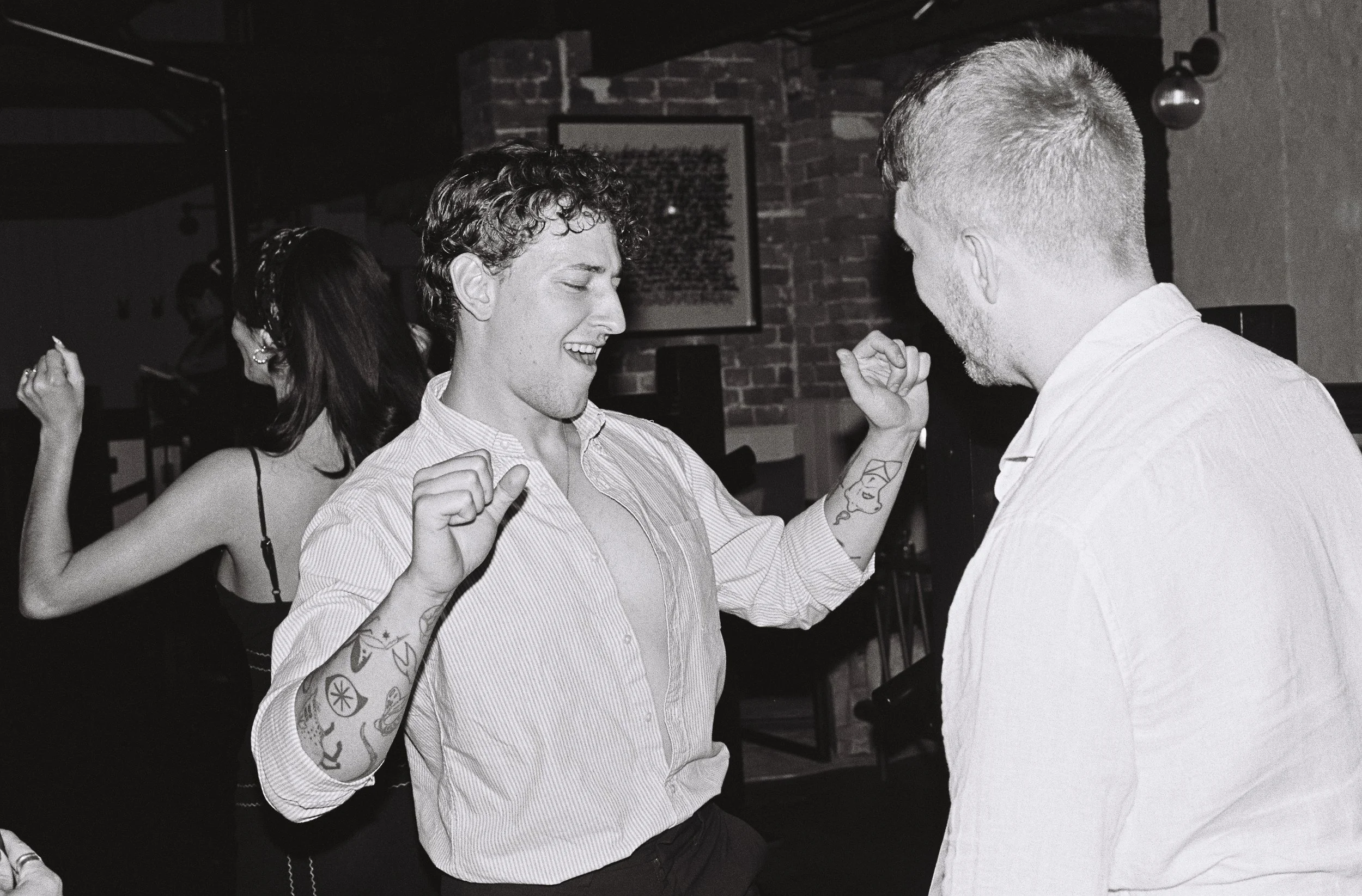 Documentary-style wedding photo taken on Kodak Tri-X film with a vintage Nikon F2 camera
