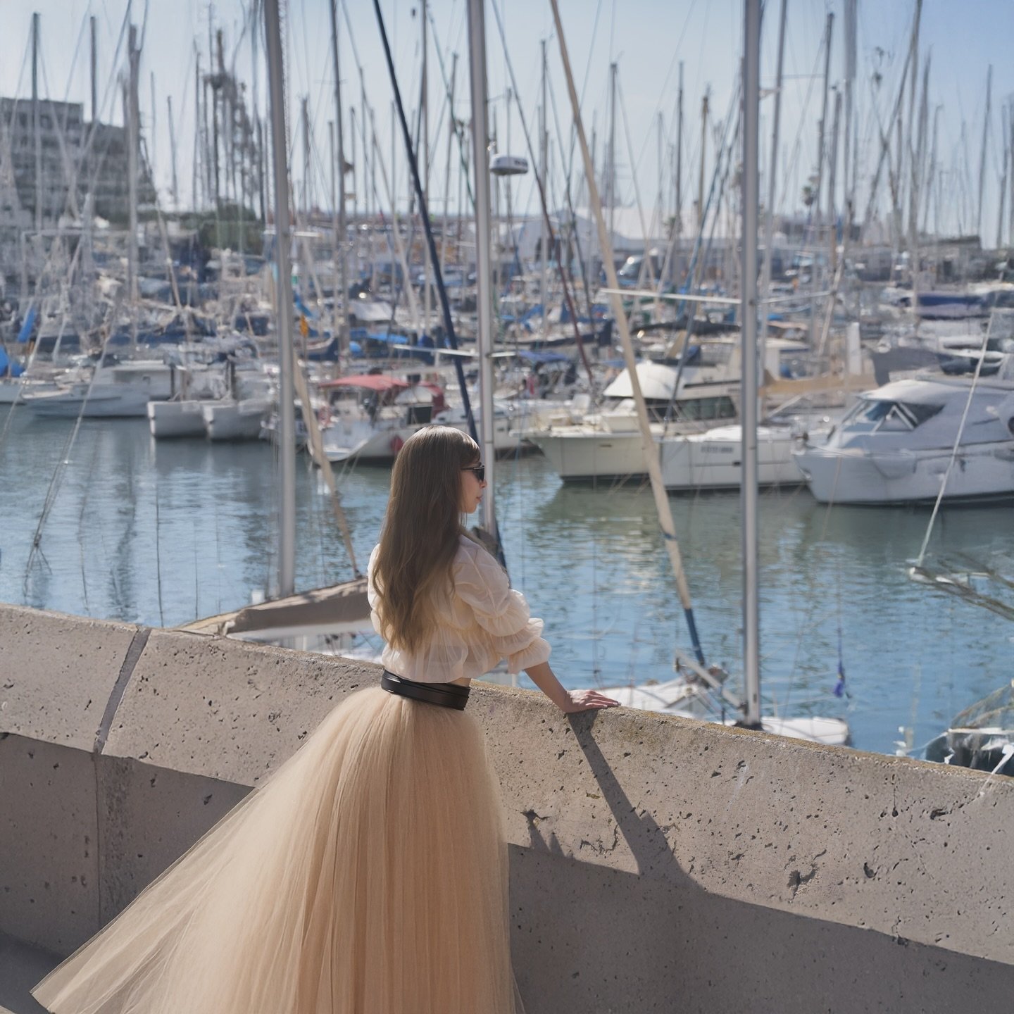 Story time!
📖🌅✨💭🌊
The sun draped itself over the marina, its warmth embracing the world as shadows danced across the dock. She stood there, still, at the edge of it all&mdash;her tulle skirt shifting ever so slightly with the breeze, a contrast t
