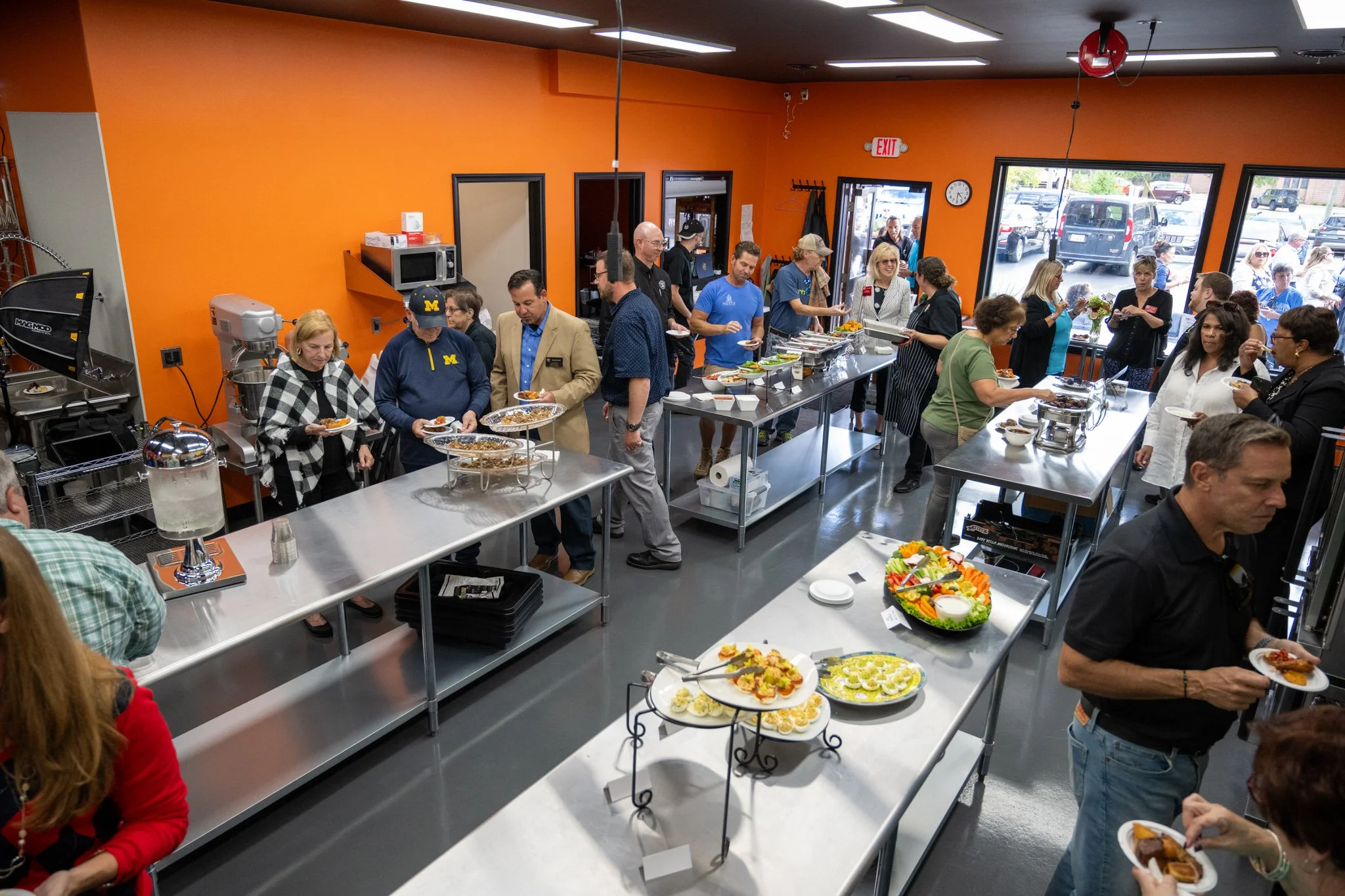 Guests socializing around dishes they made in our kitchen