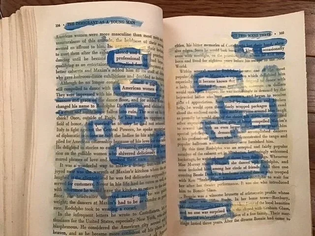 Gold and blue paint on the pages of an old book reveals a new text.