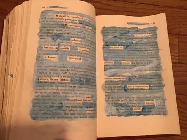 Blue and white paint on the pages of a book reveal a new text.