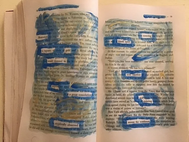 Gold and blue paint on the pages of a book reveal a new text.