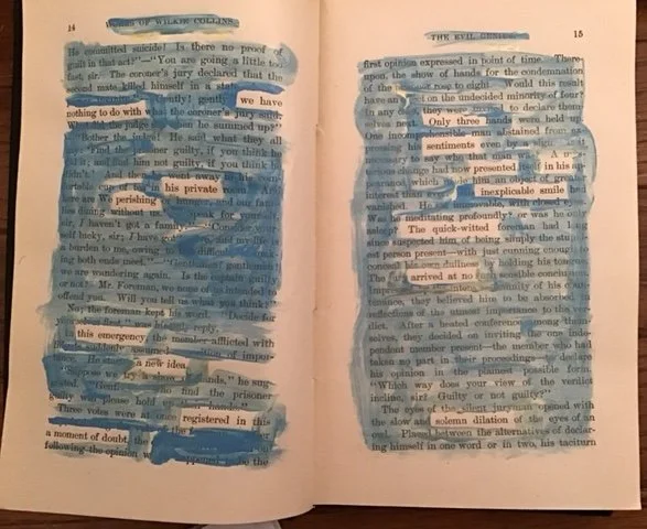 Blue and gold paint on the pages of an old book reveal a new text.