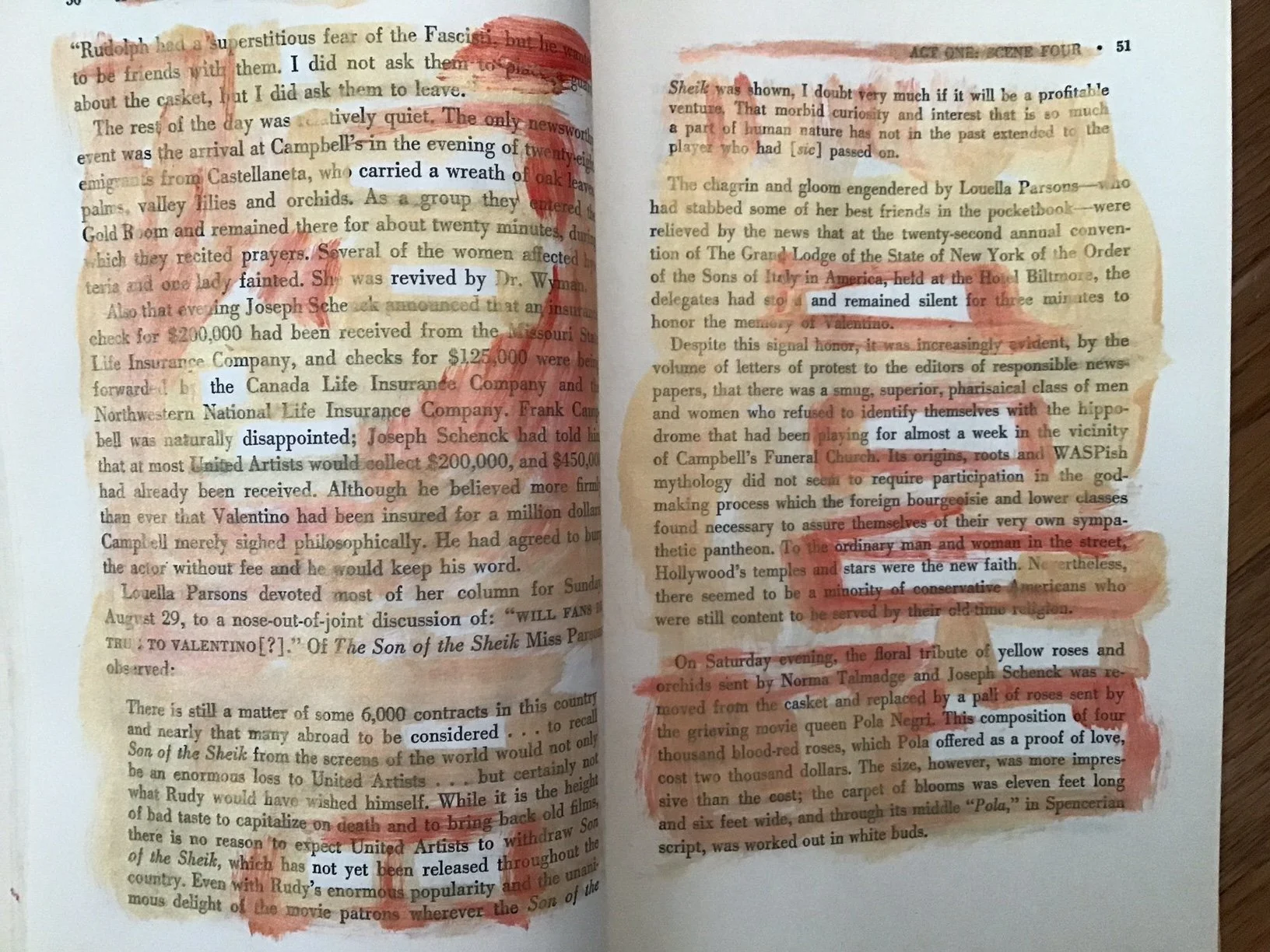 Gold and red paint on the pages of a book reveals a new text.