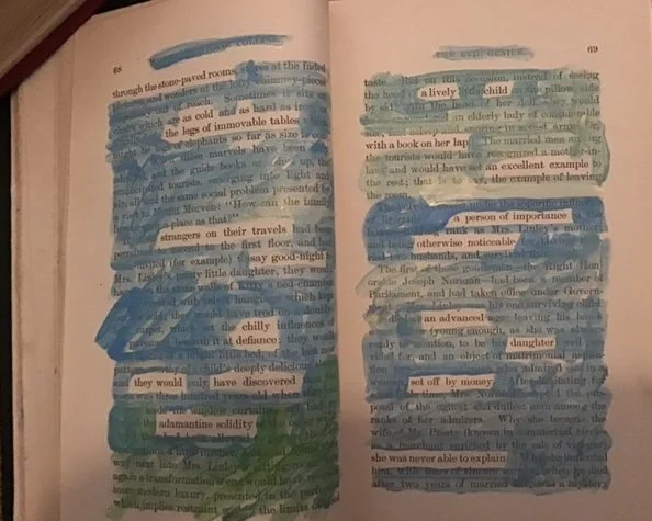 Blue and gold paint on the pages of an old book  reveal a new text.
