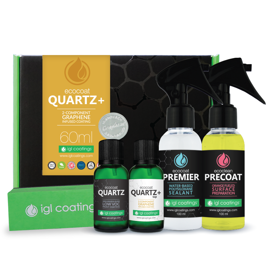 Set of eco-coat quartz and graphene coating products, including spray bottles labeled Premier and Precoat, small bottles labeled Quartz and Quartz+, and a yellow and black box with product details, all with green and black packaging.