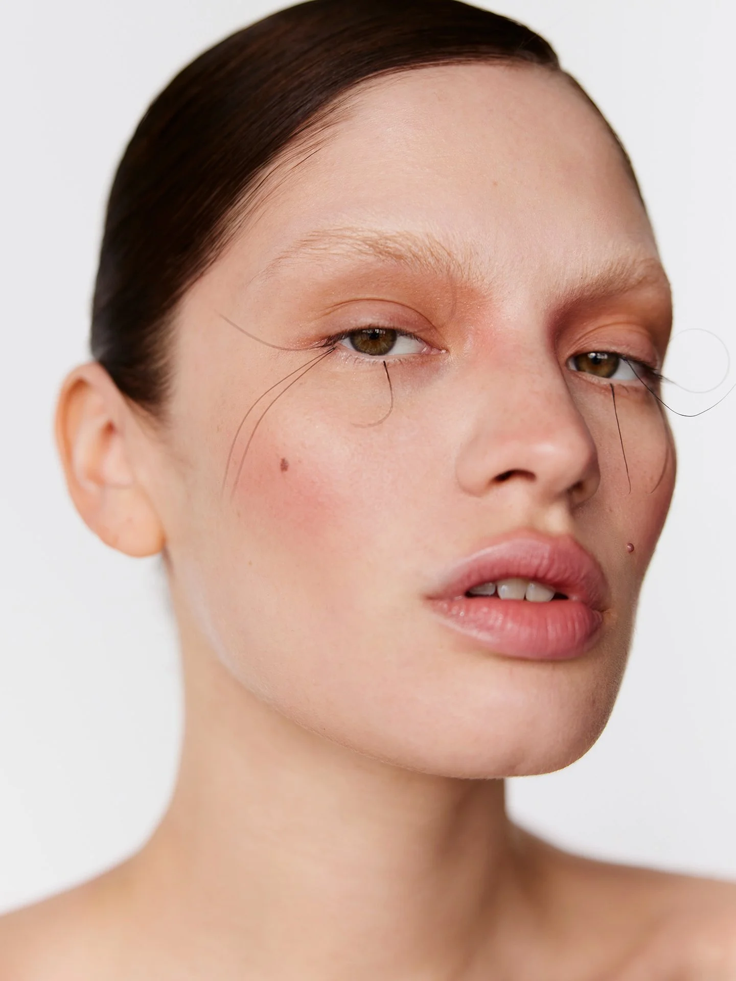 Fine red-line eye makeup detail by a beauty photographer based in Warsaw, Poland