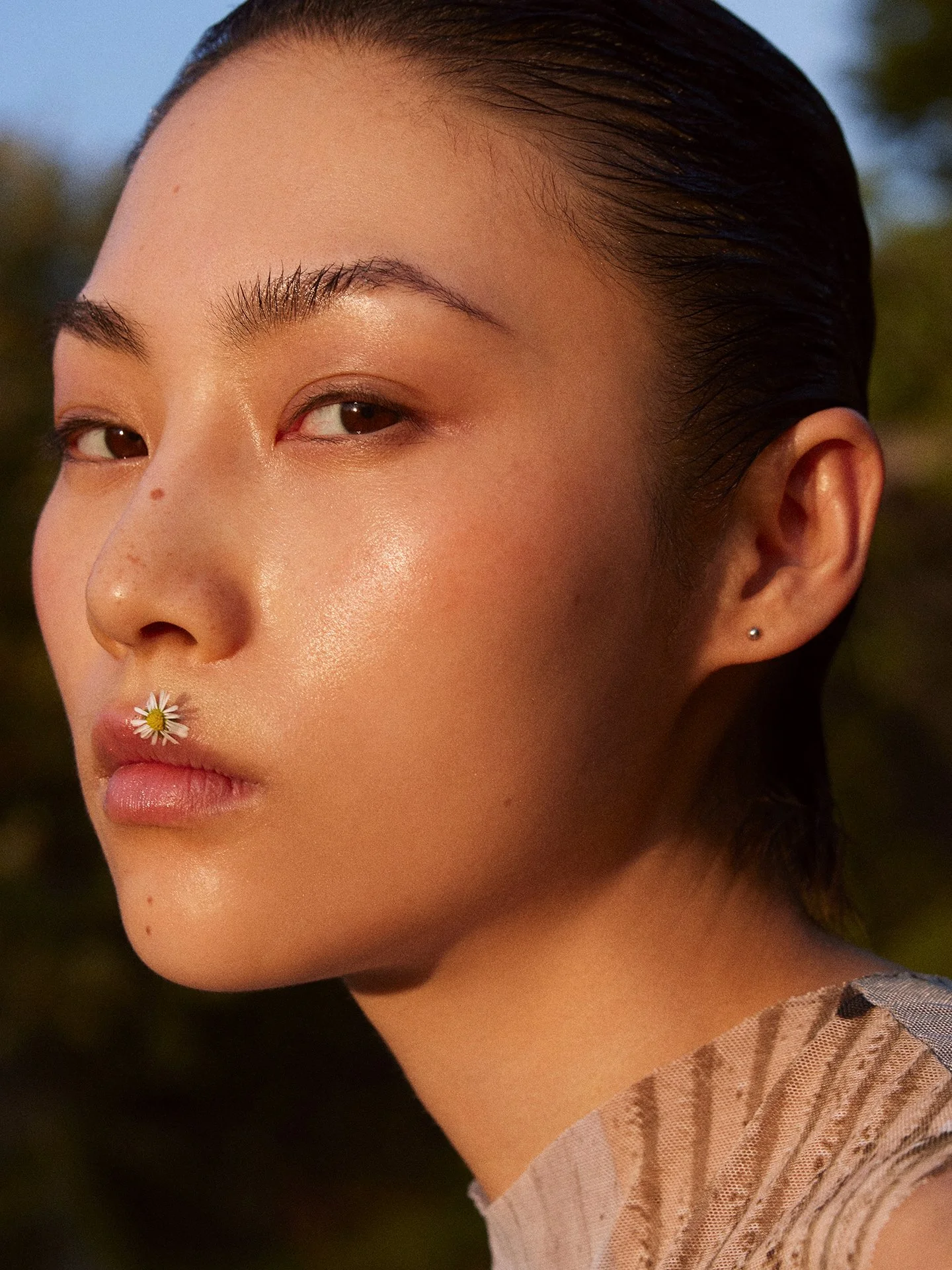 Natural beauty portrait with floral detail on lips by a beauty photographer working in London and Europe