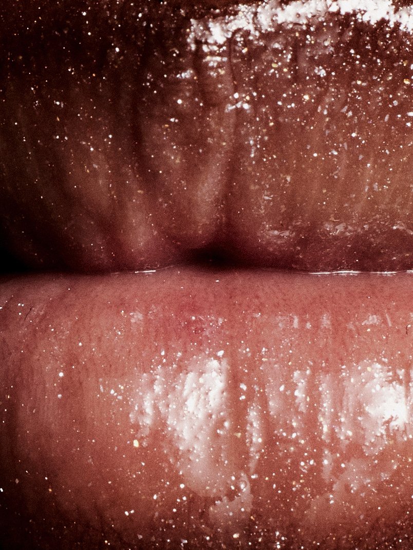 Extreme close-up glossy lips beauty shot by a beauty photographer based in Warsaw, Poland