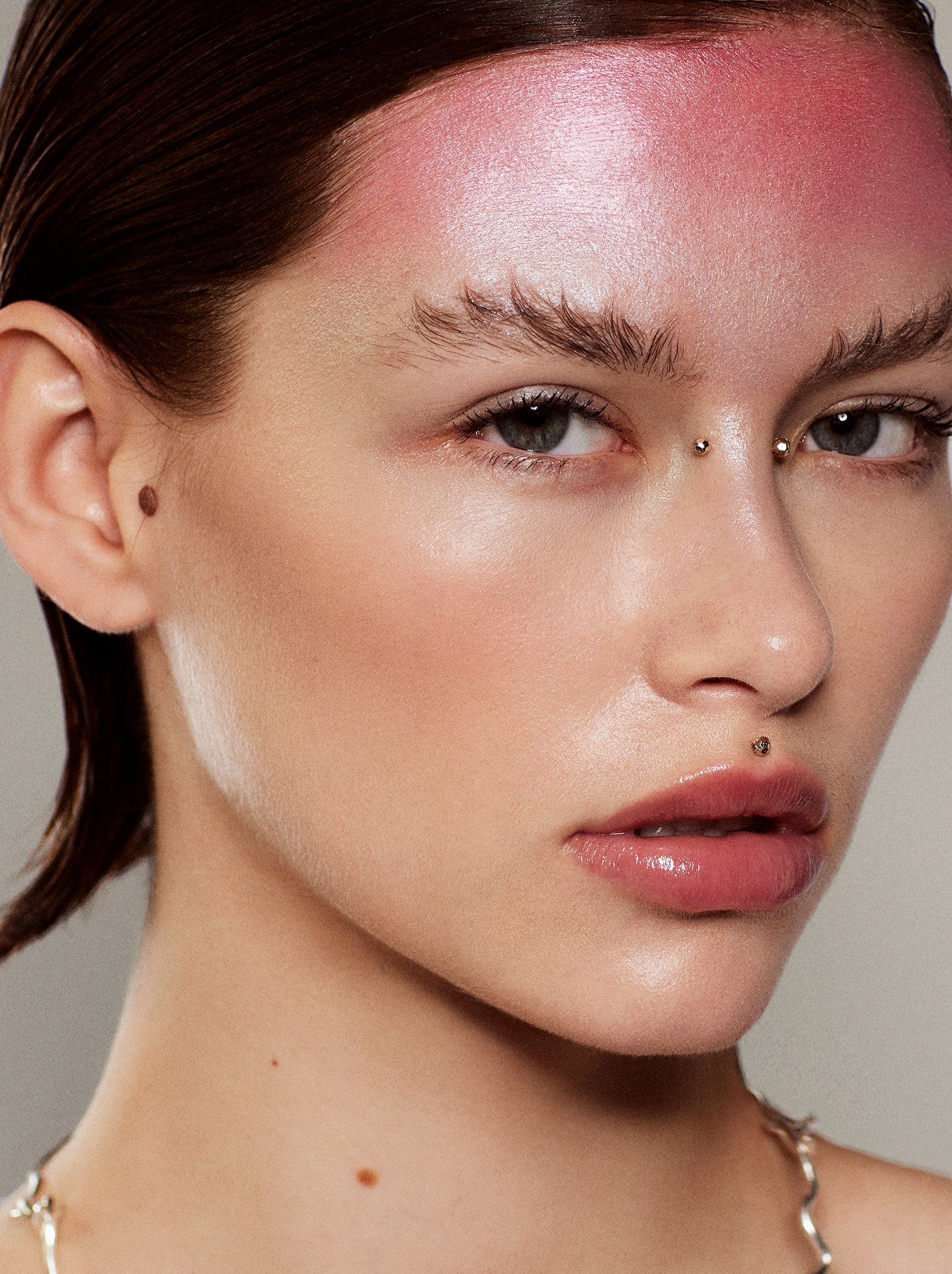 Pink shimmer forehead beauty makeup portrait by a beauty photographer working across Europe