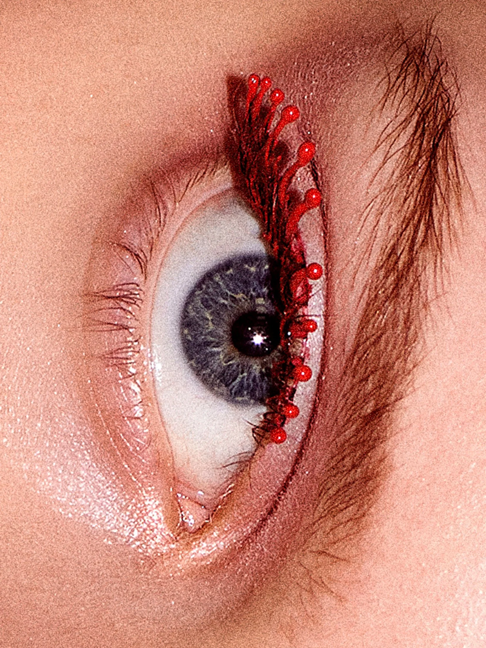 Close-up glitter red eye makeup beauty detail by a beauty photographer based in Warsaw, Poland