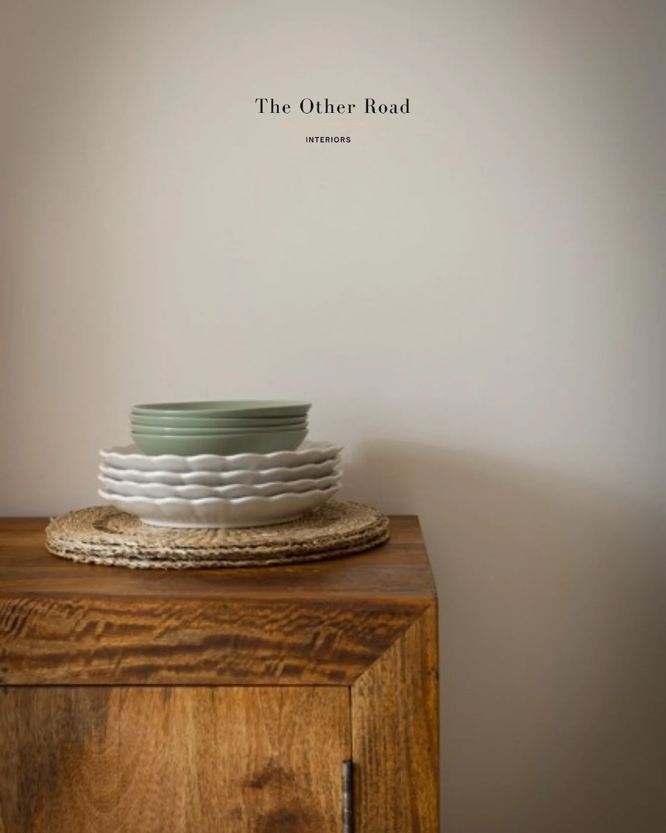 This corner tells a story in layers: 
A natural wood grain, grounding and warm. 
A ripple edged plate stack, playful and imperfect. 
A quiet sage green, soft as air. 
When every piece is chosen with care, you don&rsquo;t need many.
 Just the right on