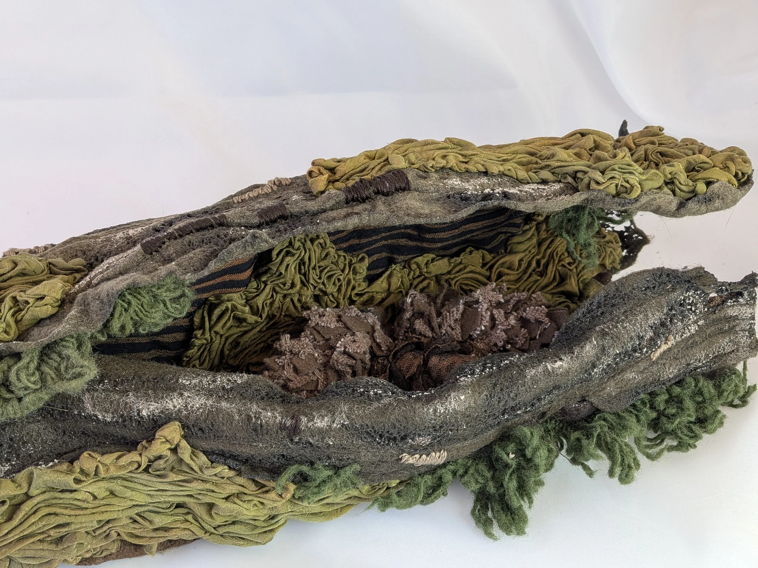 Pinecones in a fiber art log