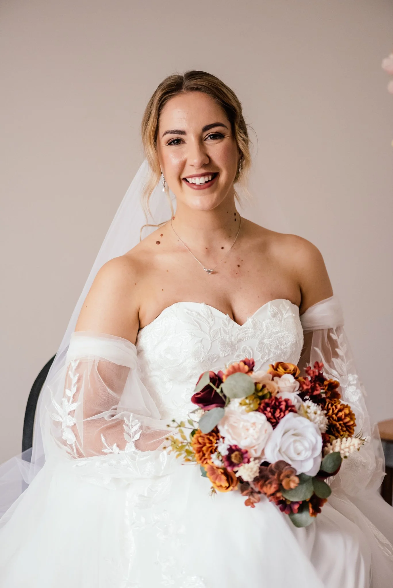 Perth Bride Meg in soft glam makeup and posing in wedding dress holding her bouquet