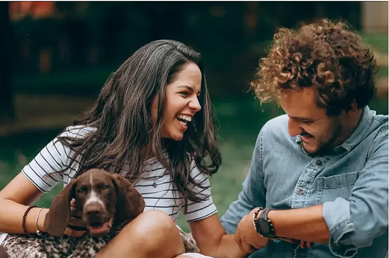 Happy couple laughing together outdoors — couples counseling in Jackson, MS
