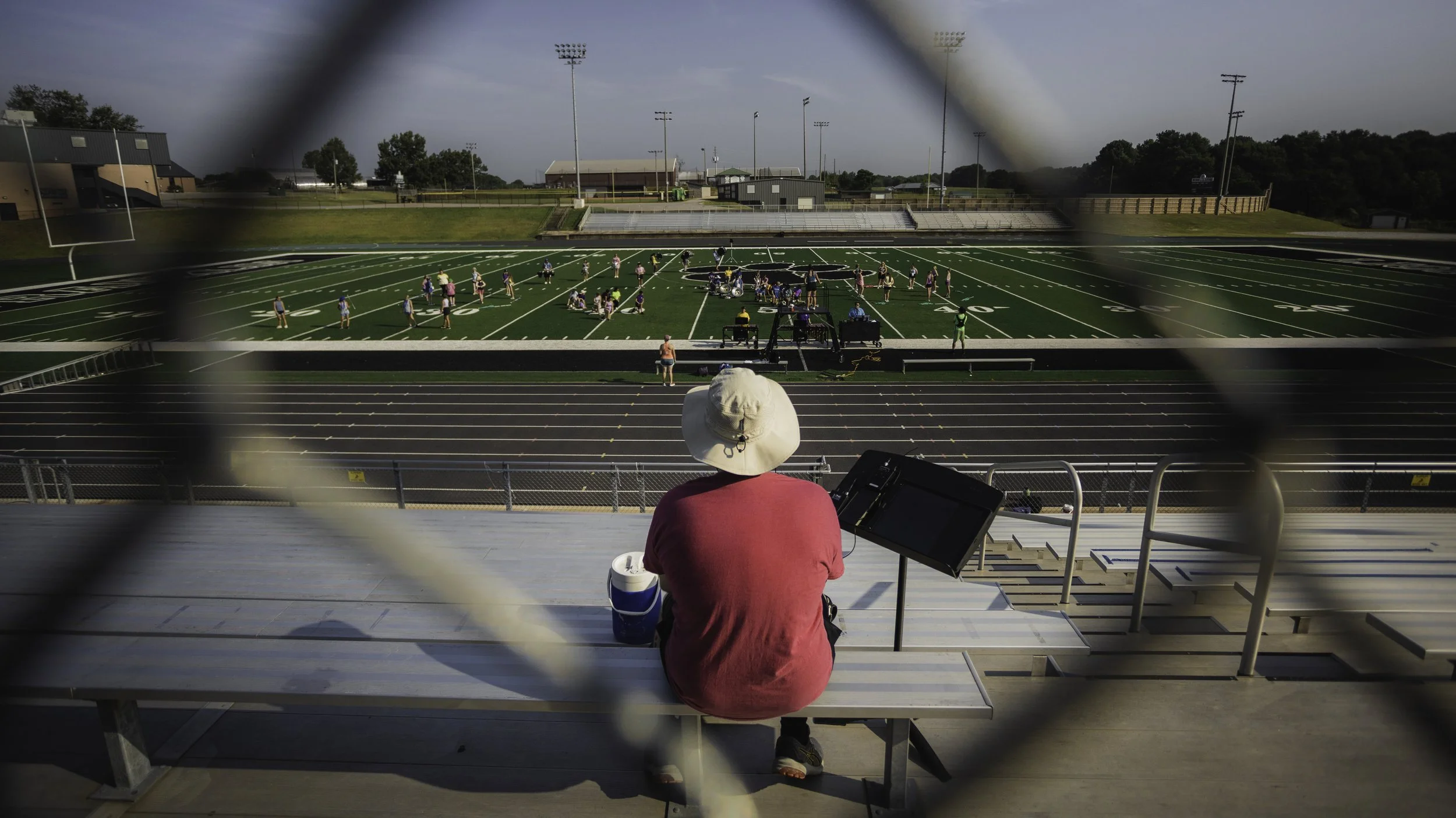 Christopher Sampson, Band Director at Franklin County High School, looks out onto the field where old faces and new friends greet each other for another year of music and memories.