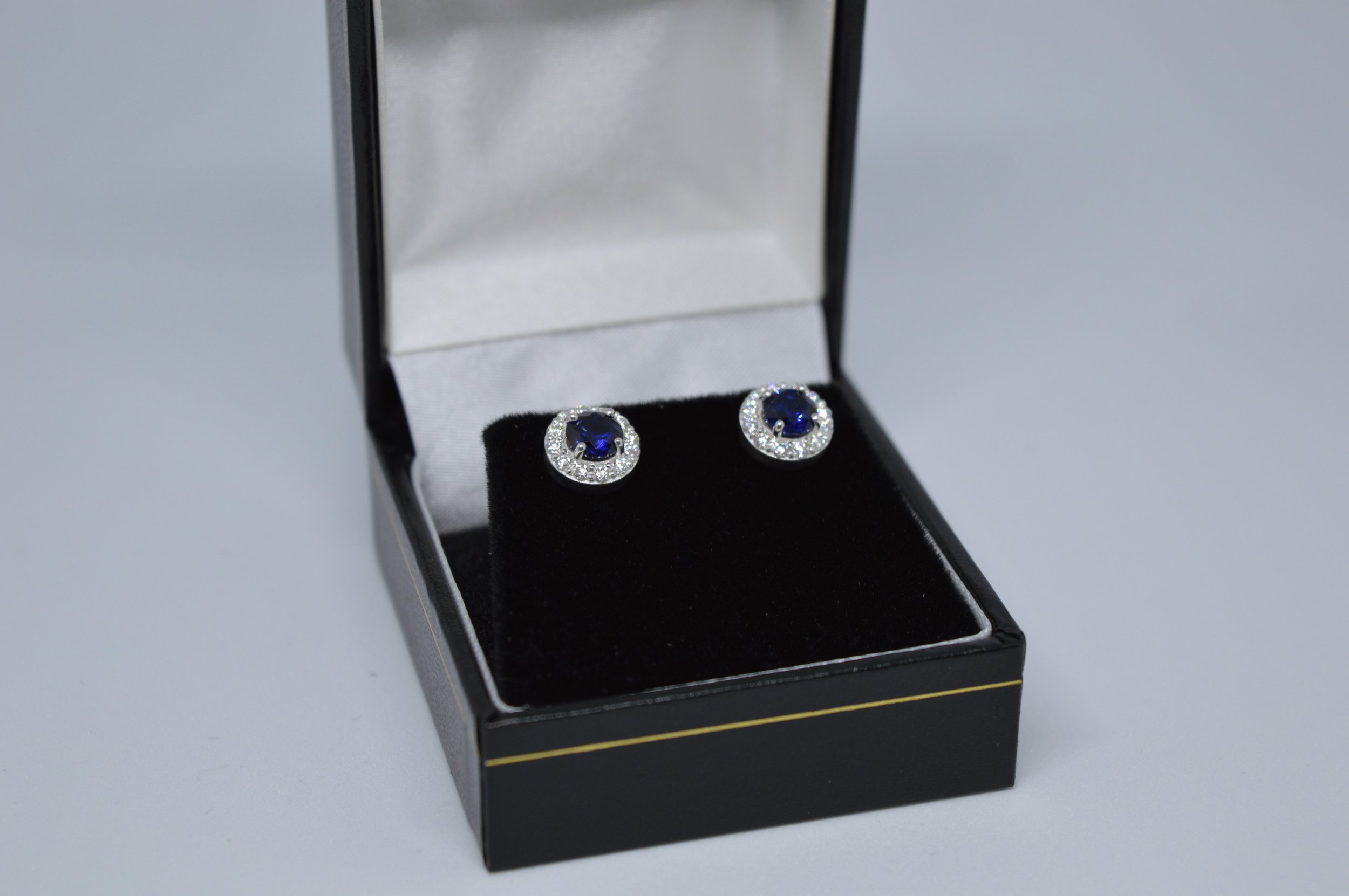 598 Sapphire Halo Earrings Box Far.jpeg